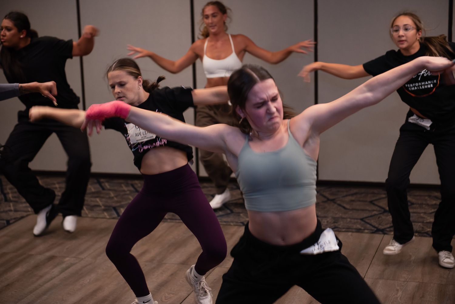 Group of dancers performing synchronized movements during stage show.