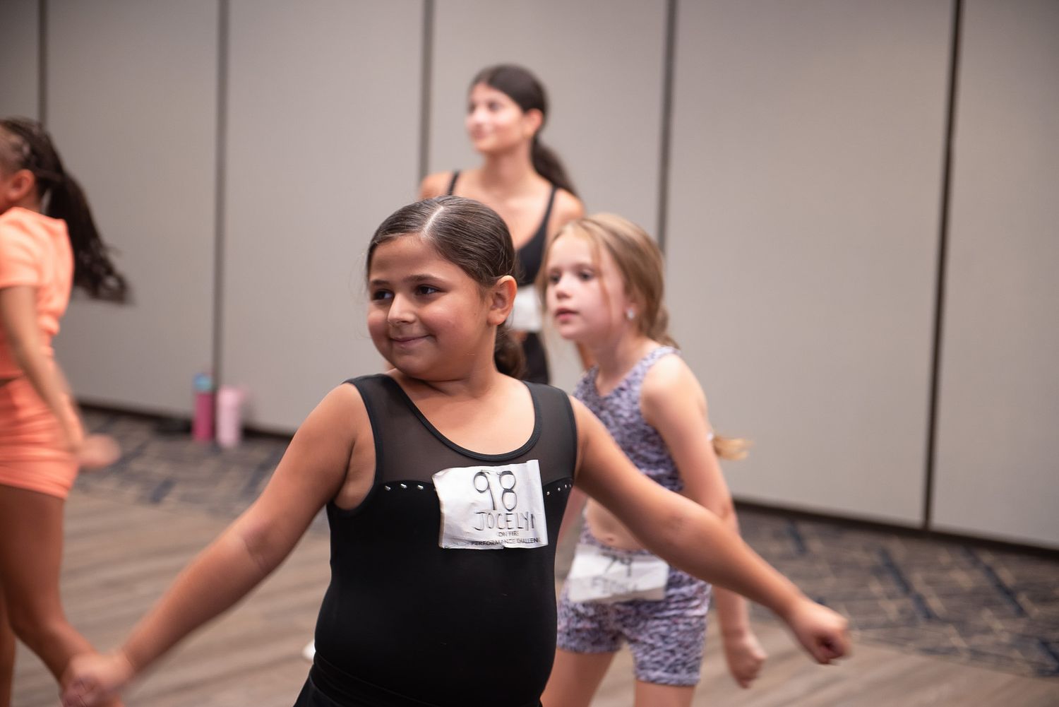 Dancers practicing choreography together in studio space.