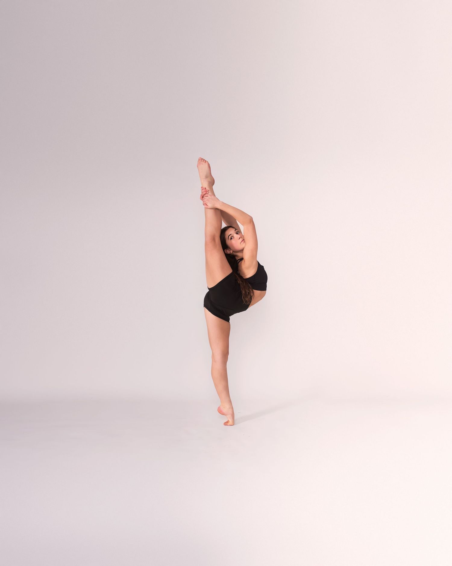 Graceful dance poses demonstrating flexibility and strength in black leotard.