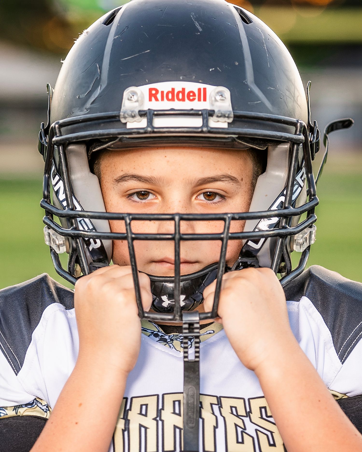 A sequence of closeup shots showing a football player's helmet and face mask from different angles.