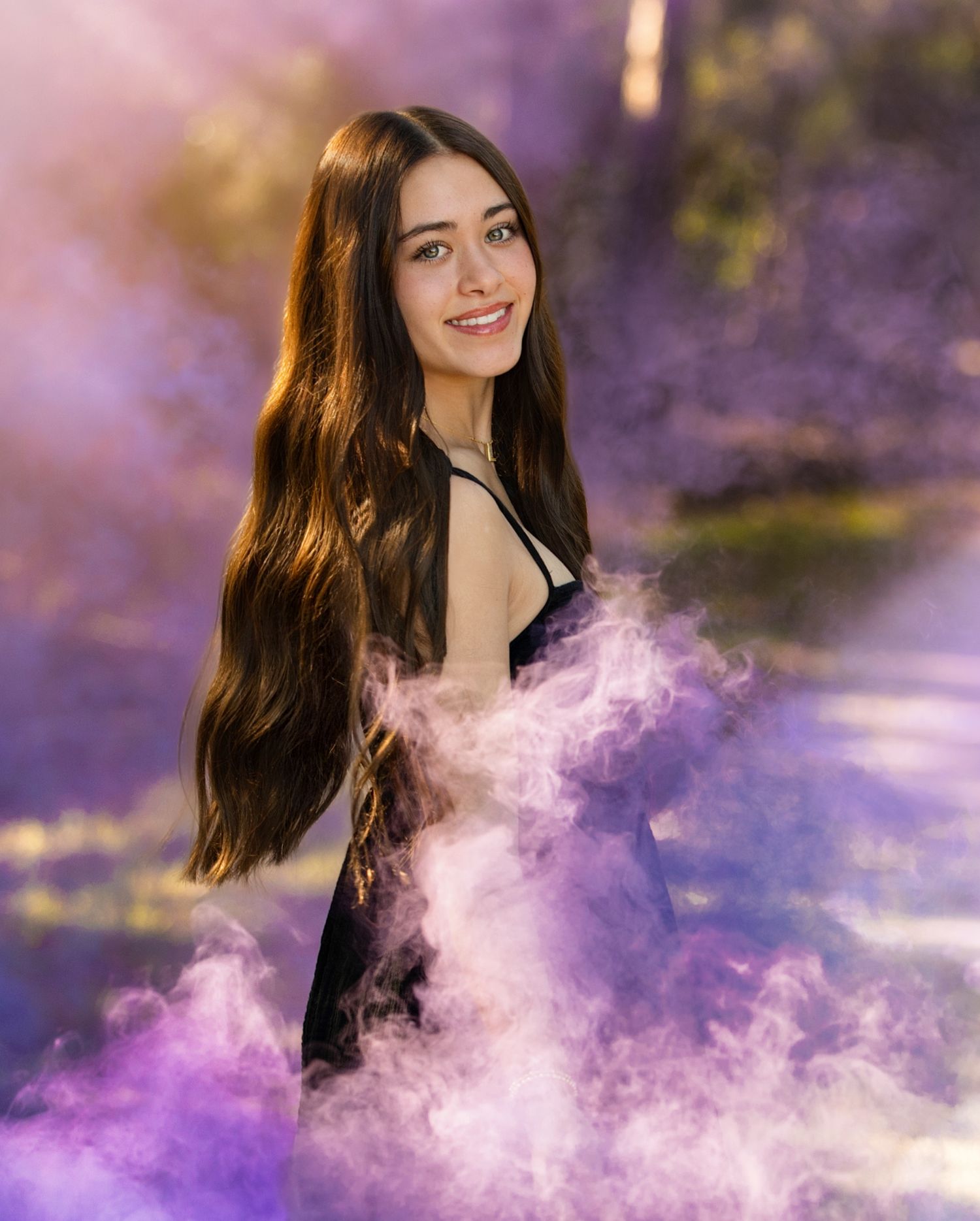 A woman with dark hair poses in a dreamy purple smoke effect creating an ethereal portrait series.