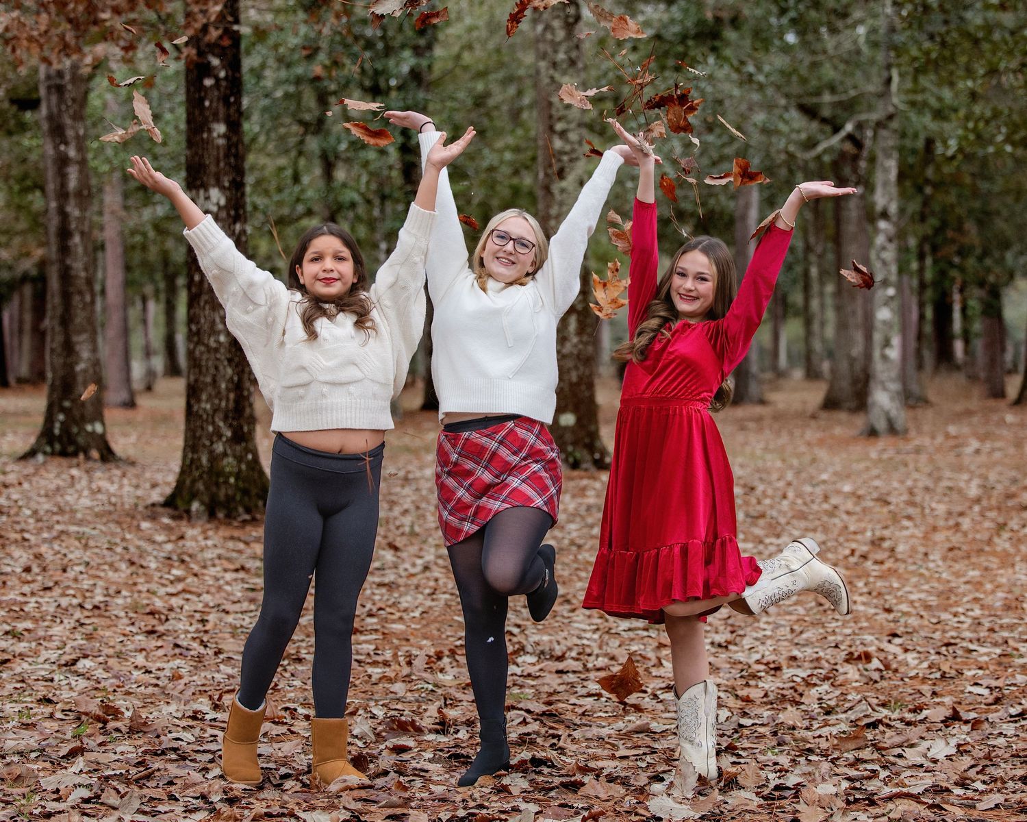 A group photo series showing people in festive outfits jumping and posing playfully on fallen leaves.