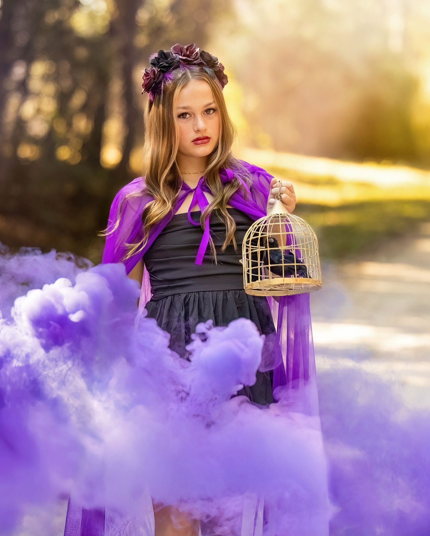 Teen Fashion portrait with purple smoke effects and vintage birdcage props in golden sunset lighting.