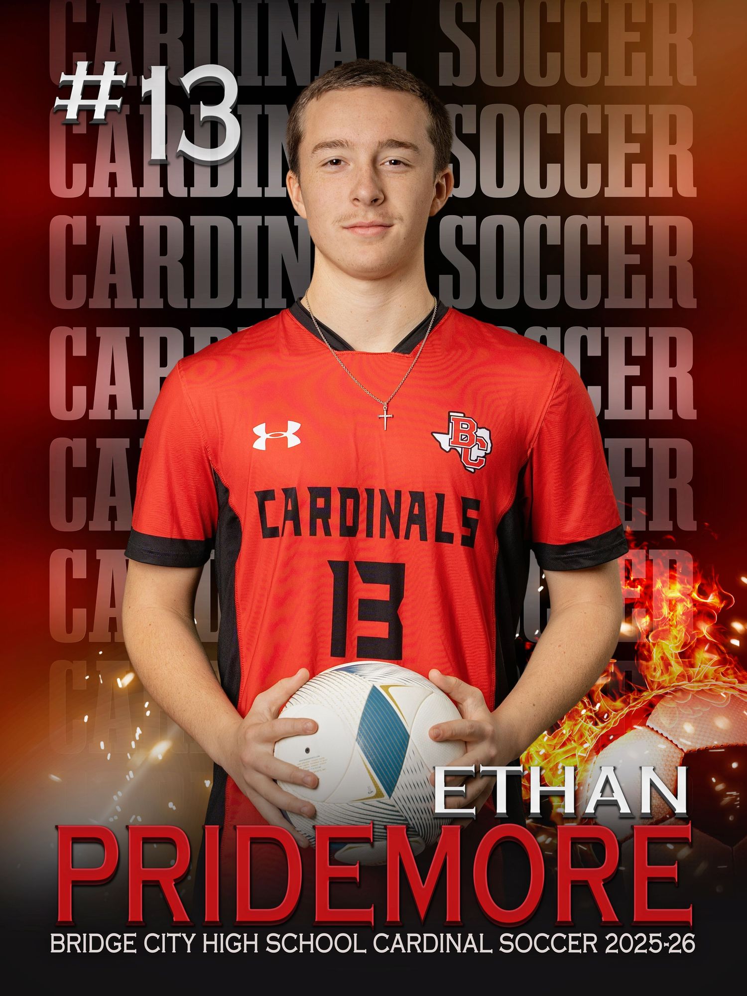 High school soccer player in red Cardinal uniform number 13 poses with soccer ball against dark backdrop.