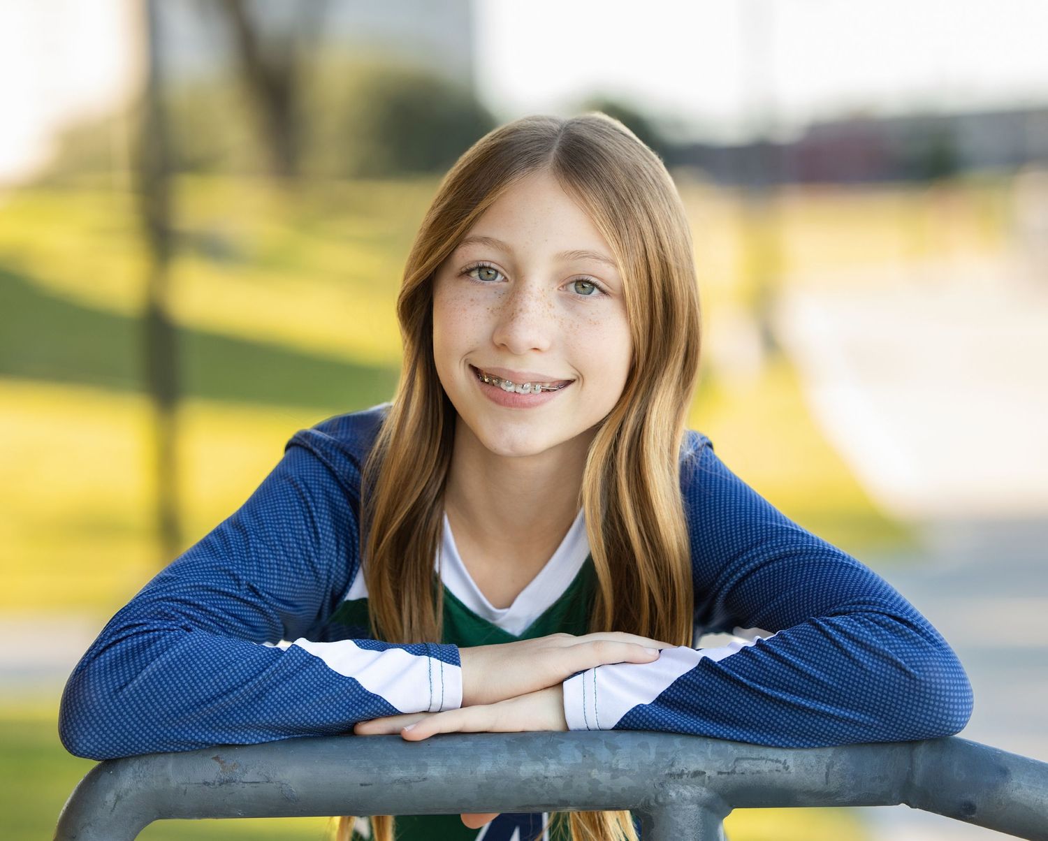 A series of four similar photos showing a person in a blue sweater resting their arms on a wooden railing outdoors.