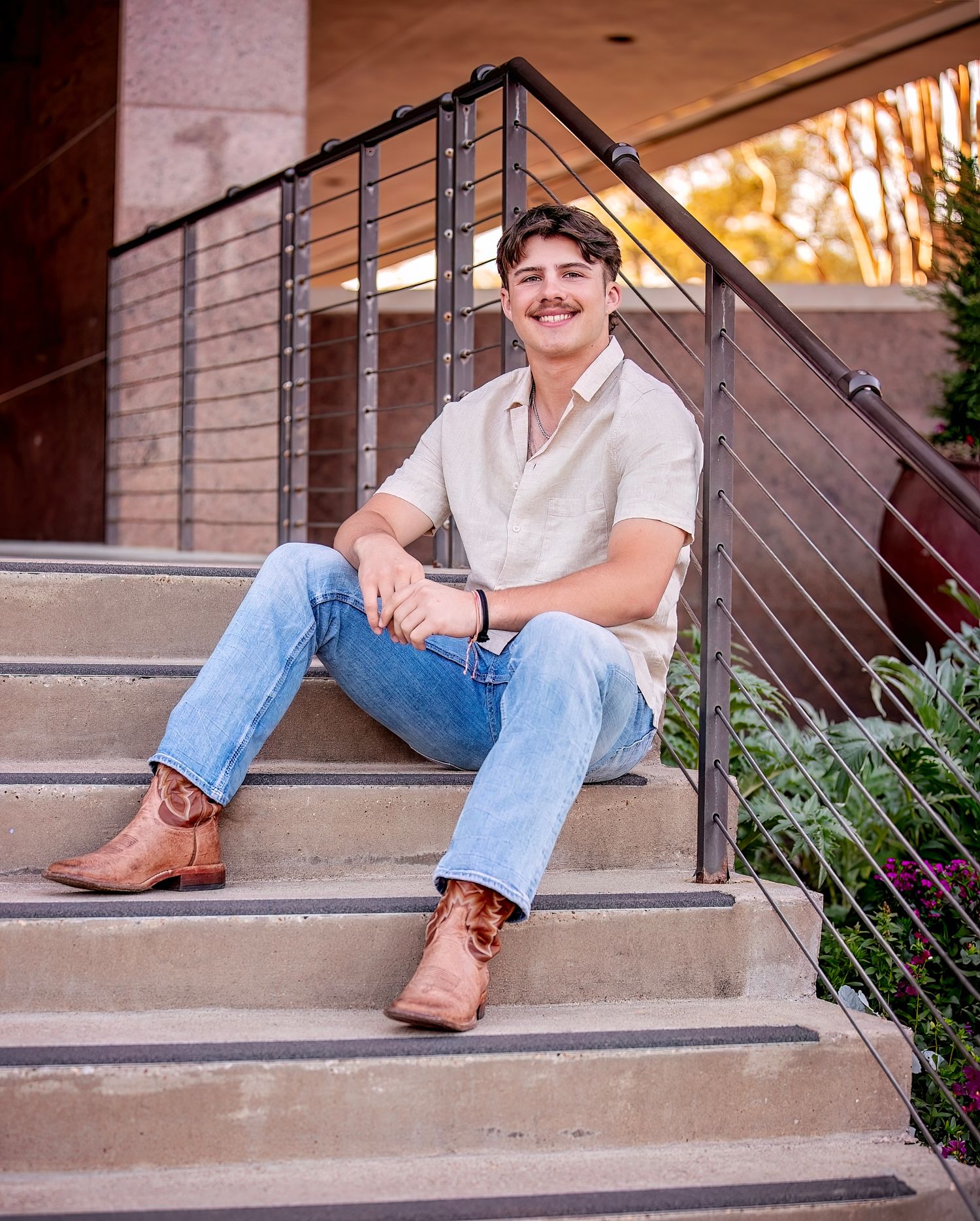 A series of outdoor portrait photos taken on concrete steps with brick walls and flowering plants in the background.