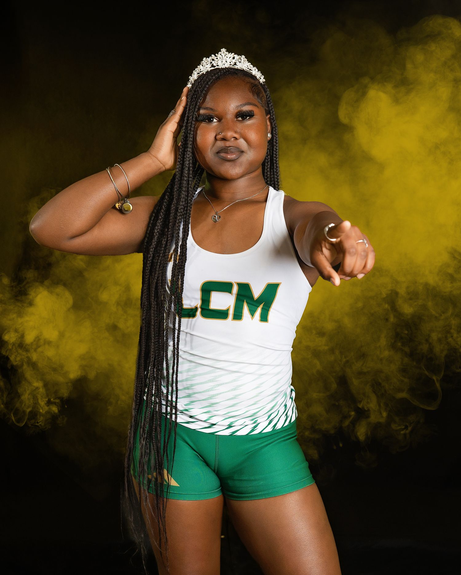 LCM track athlete poses confidently against dramatic yellow smoke background for professional photoshoot.