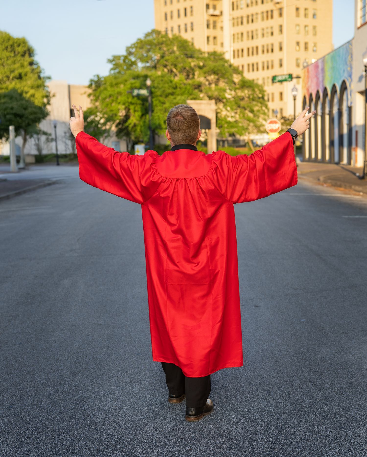 A sequence of five photos showing a person in a bright red jacket spreading their arms wider in each progressive shot.