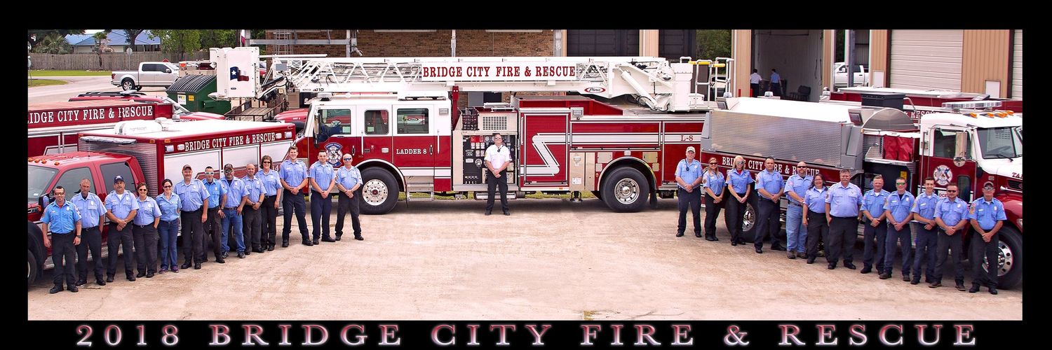 Bridge City Fire Department Panoramic group photo of firefighters and rescue personnel standing in formation outside a fire station.