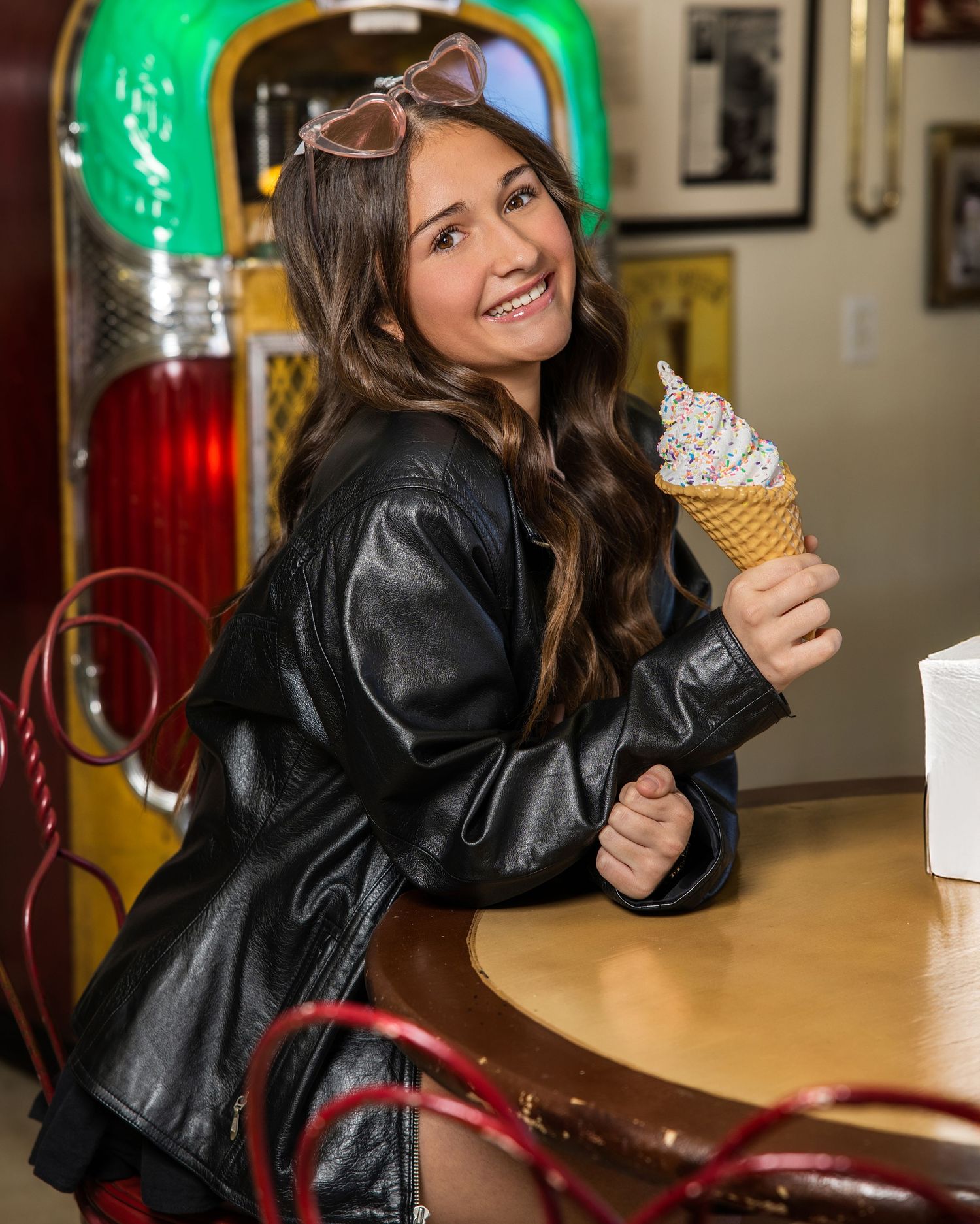Retro diner scene with leather jacket and ice cream cone at vintage counter.