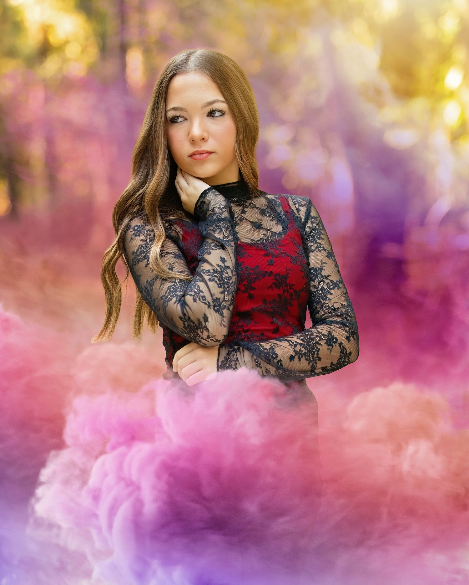 Artistic portrait with pink smoke effects and black lace dress against autumn backdrop.