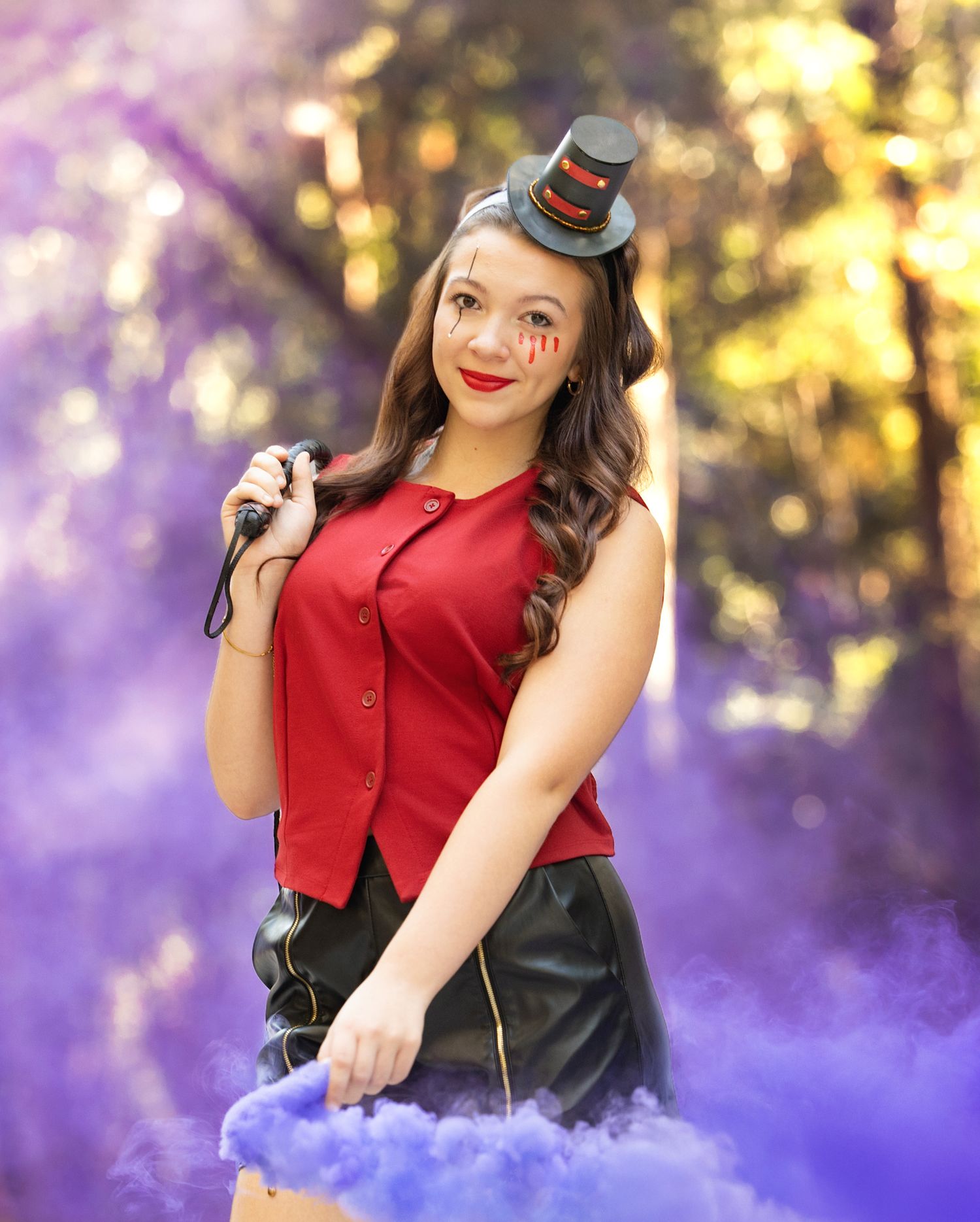 Atalyn  vintage-inspired red vest and black skirt poses outdoors with purple smoke effect  had the perfect colors