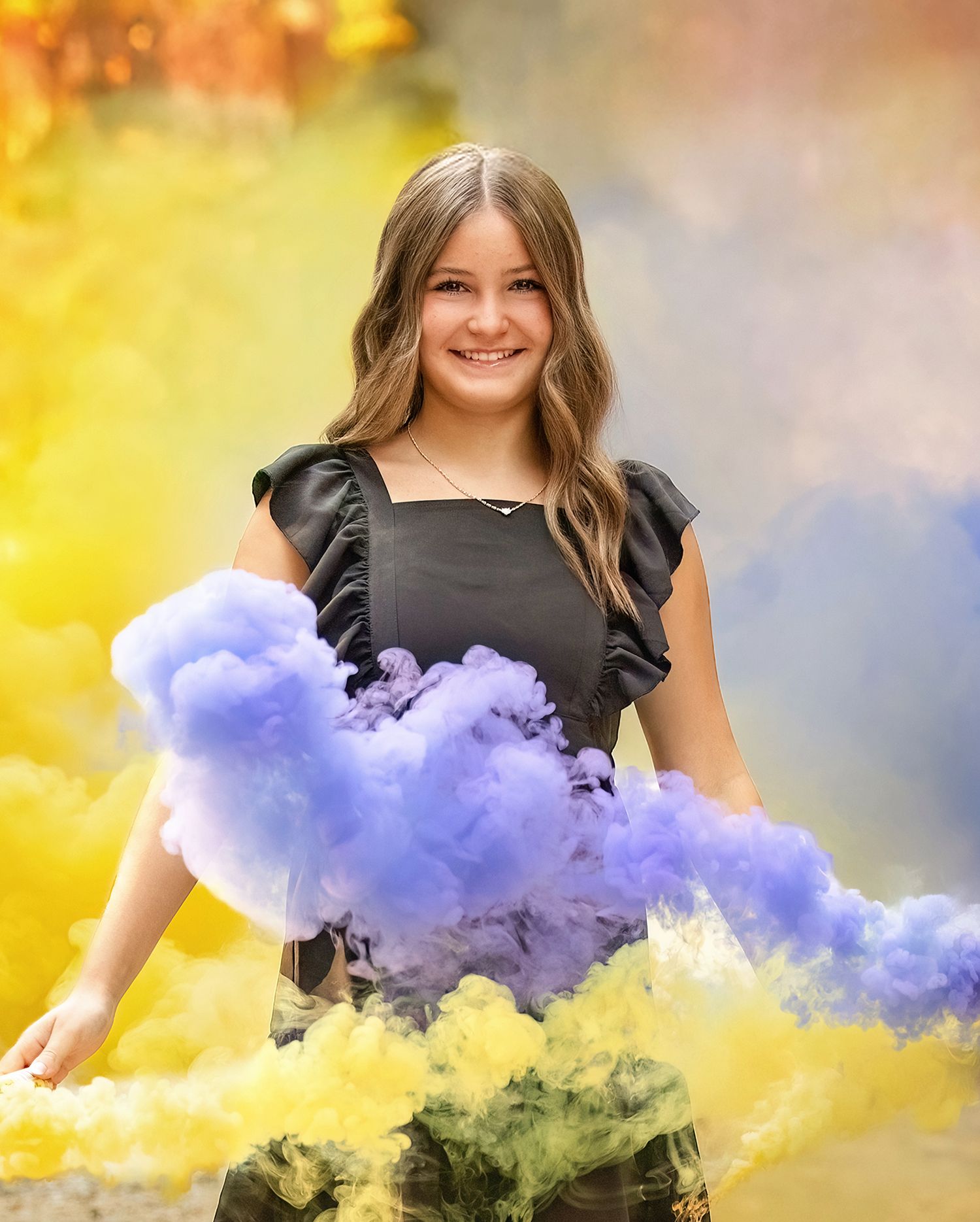 Portrait session with colorful yellow and purple smoke effects outdoors.