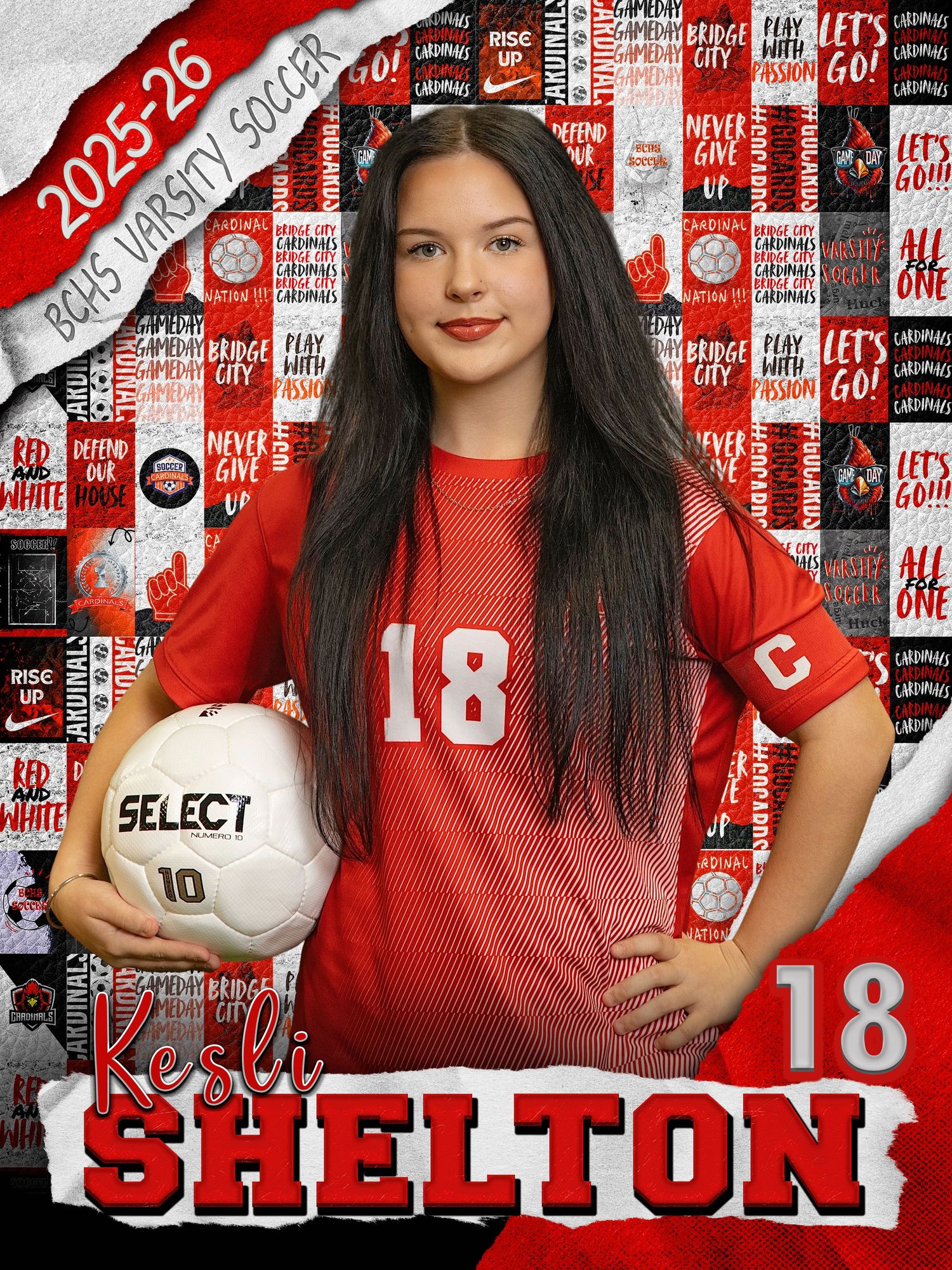 Soccer player in red uniform number 18 poses with ball against branded backdrop.