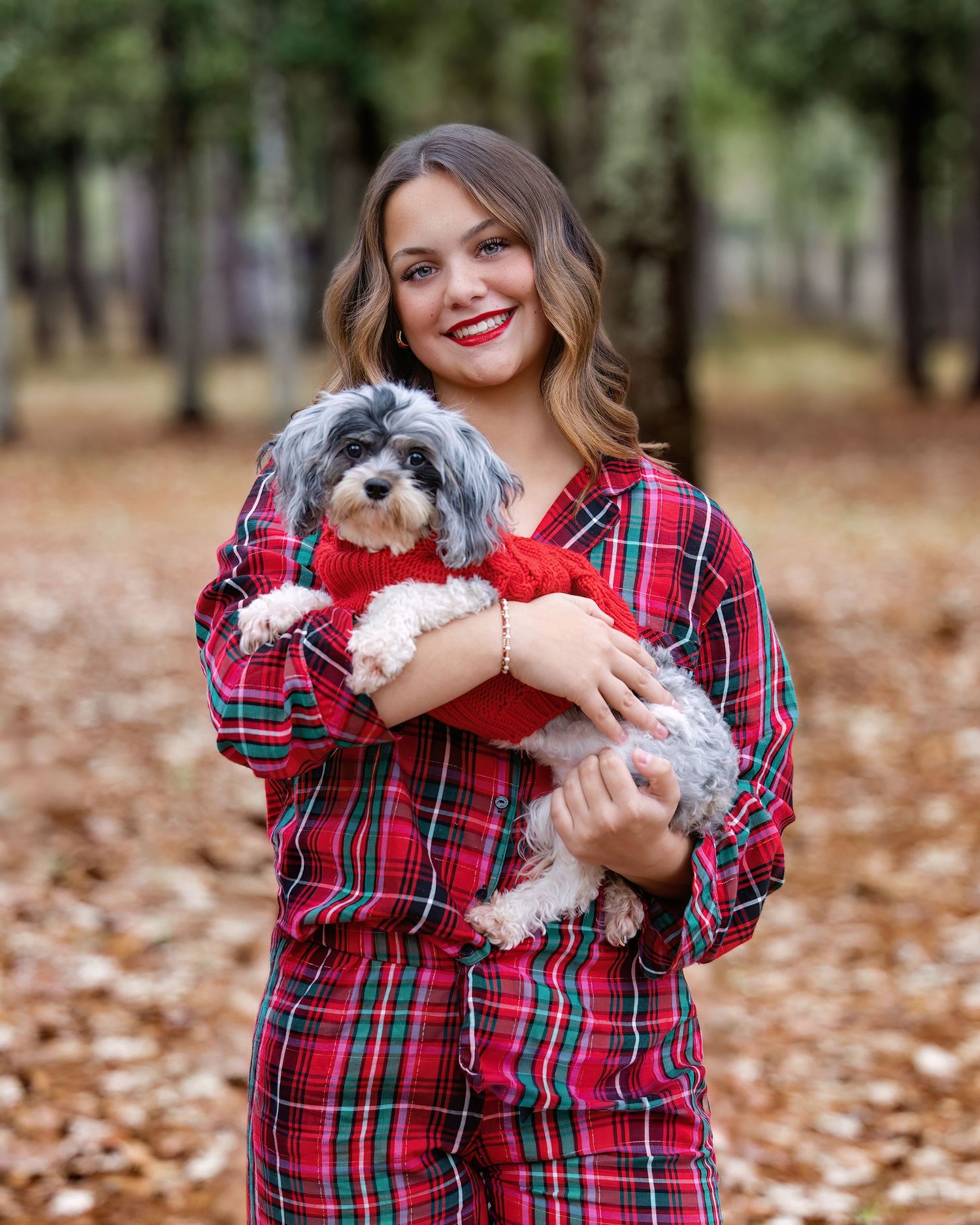 A series of fall photos showing someone in a red plaid shirt holding a small white dog among autumn leaves.