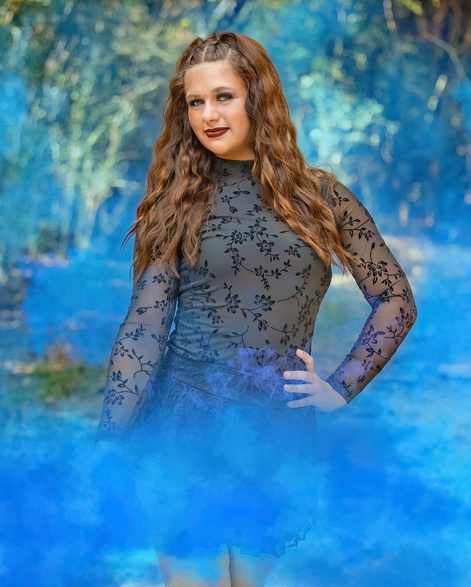 Artistic portrait against a vibrant blue background featuring a black lace top.