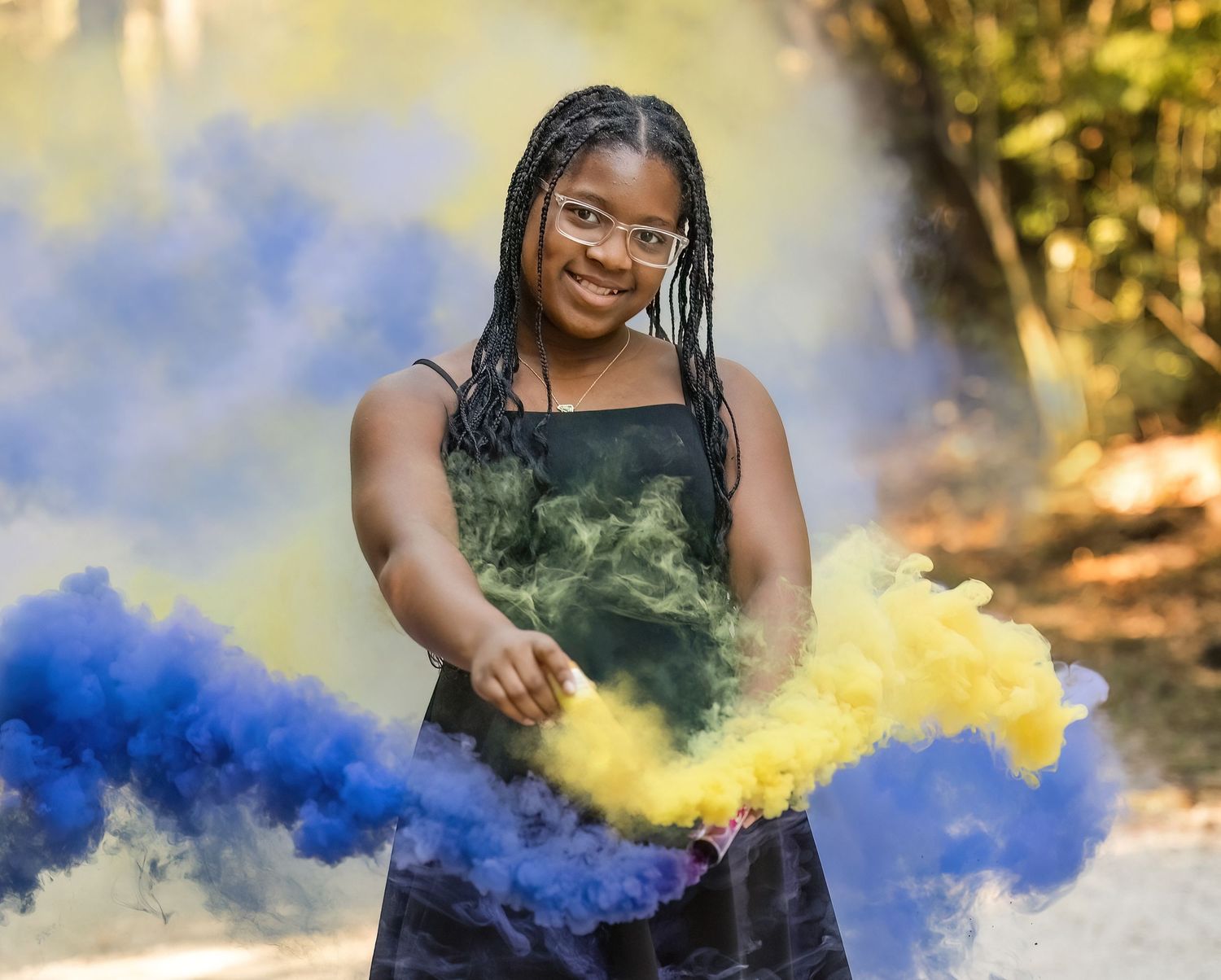 Artistic photo series featuring colorful smoke bombs creating yellow and blue effects outdoors.