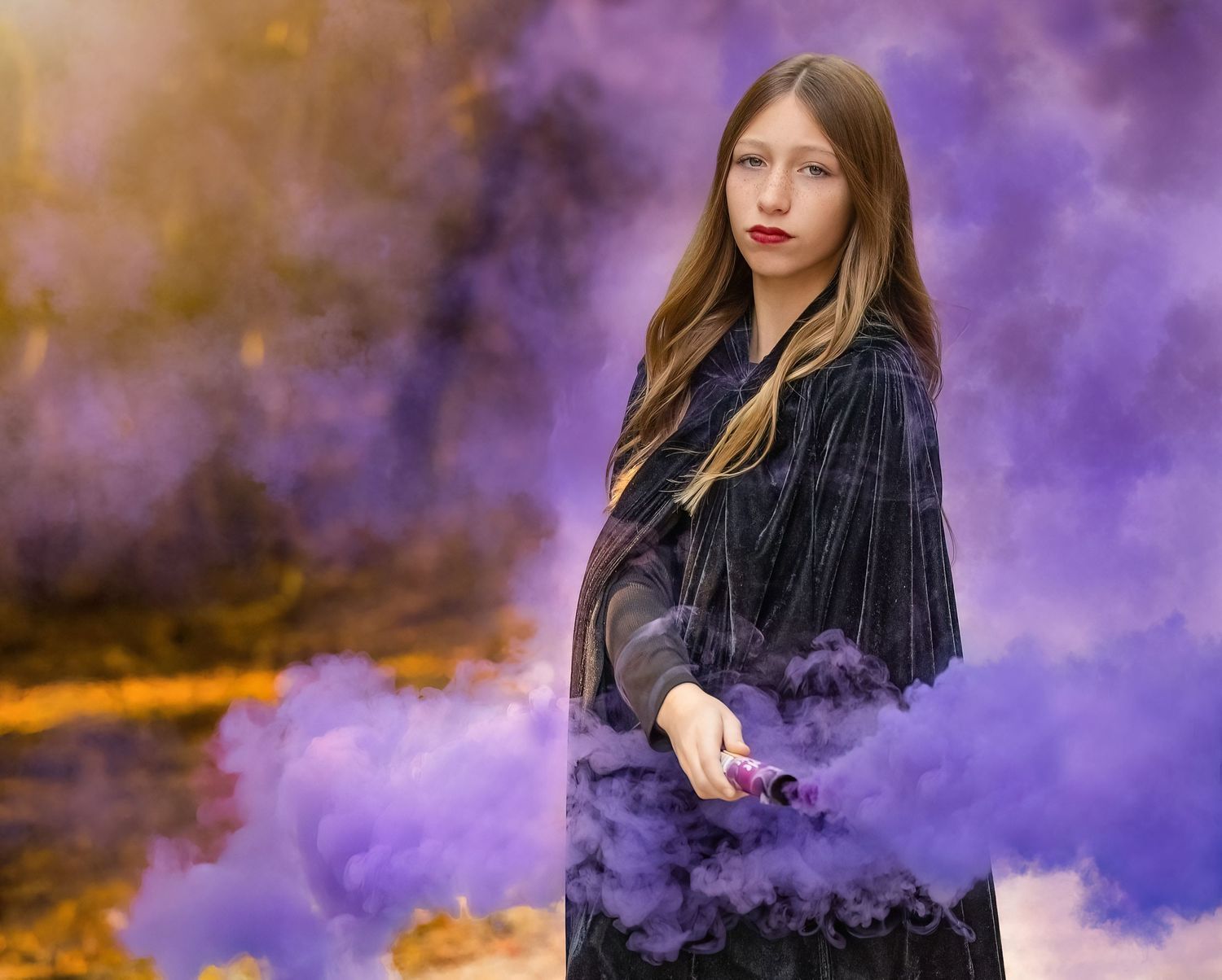 Dramatic portrait featuring purple smoke effects and moody lighting.