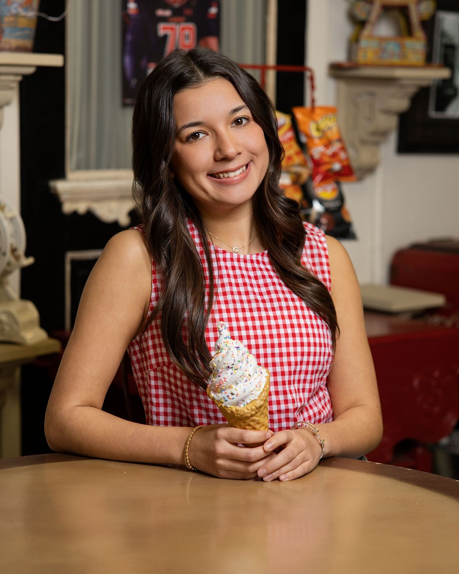 A series of photos showing someone in a red and white gingham dress sitting at a wooden table with a dessert.