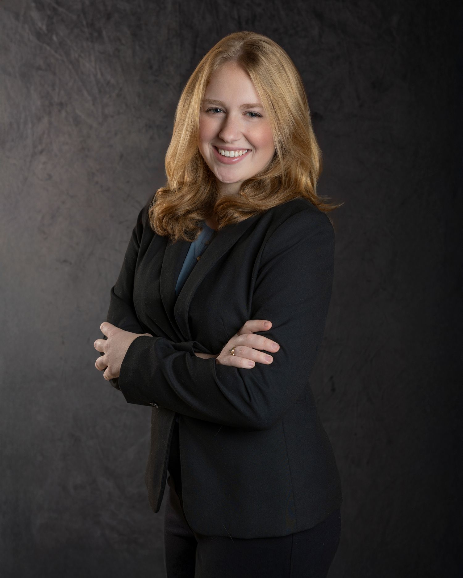 Professional portrait series showing a person in a black blazer against a dark background posing with different expressions.