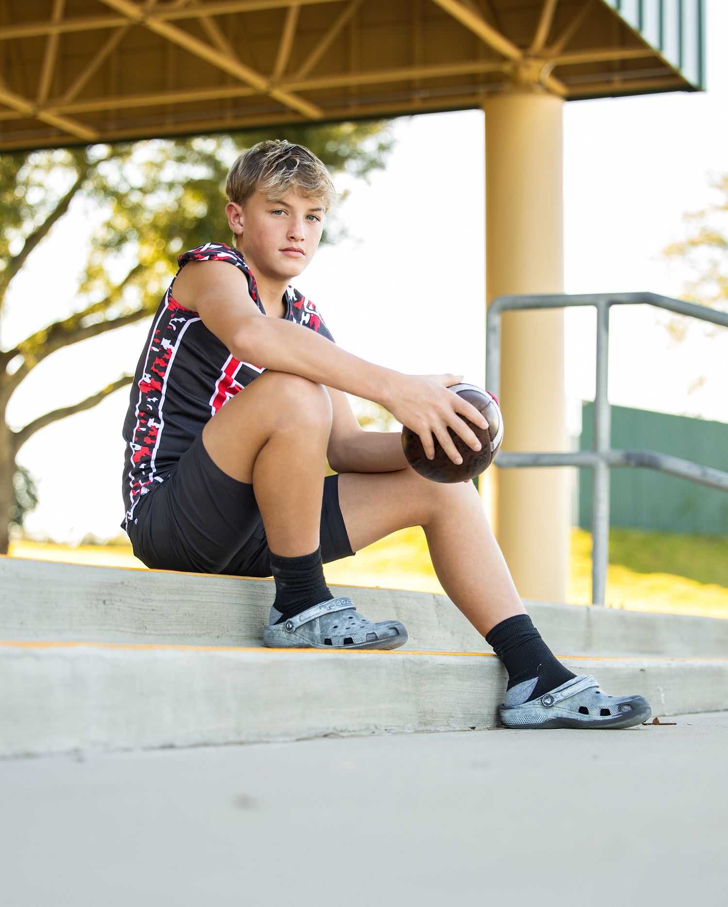 A sequence showing legs sitting on concrete steps in athletic wear and socks.