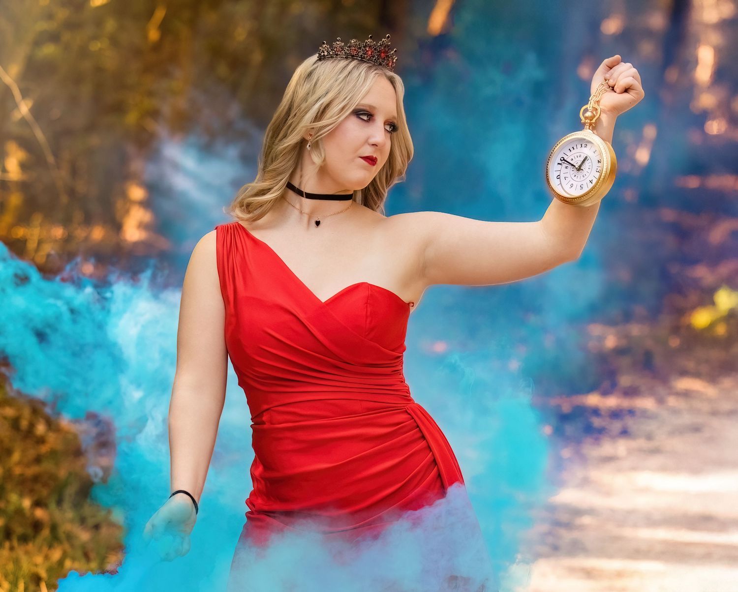 Person in red dress holds pocket watch amid blue smoke effects.