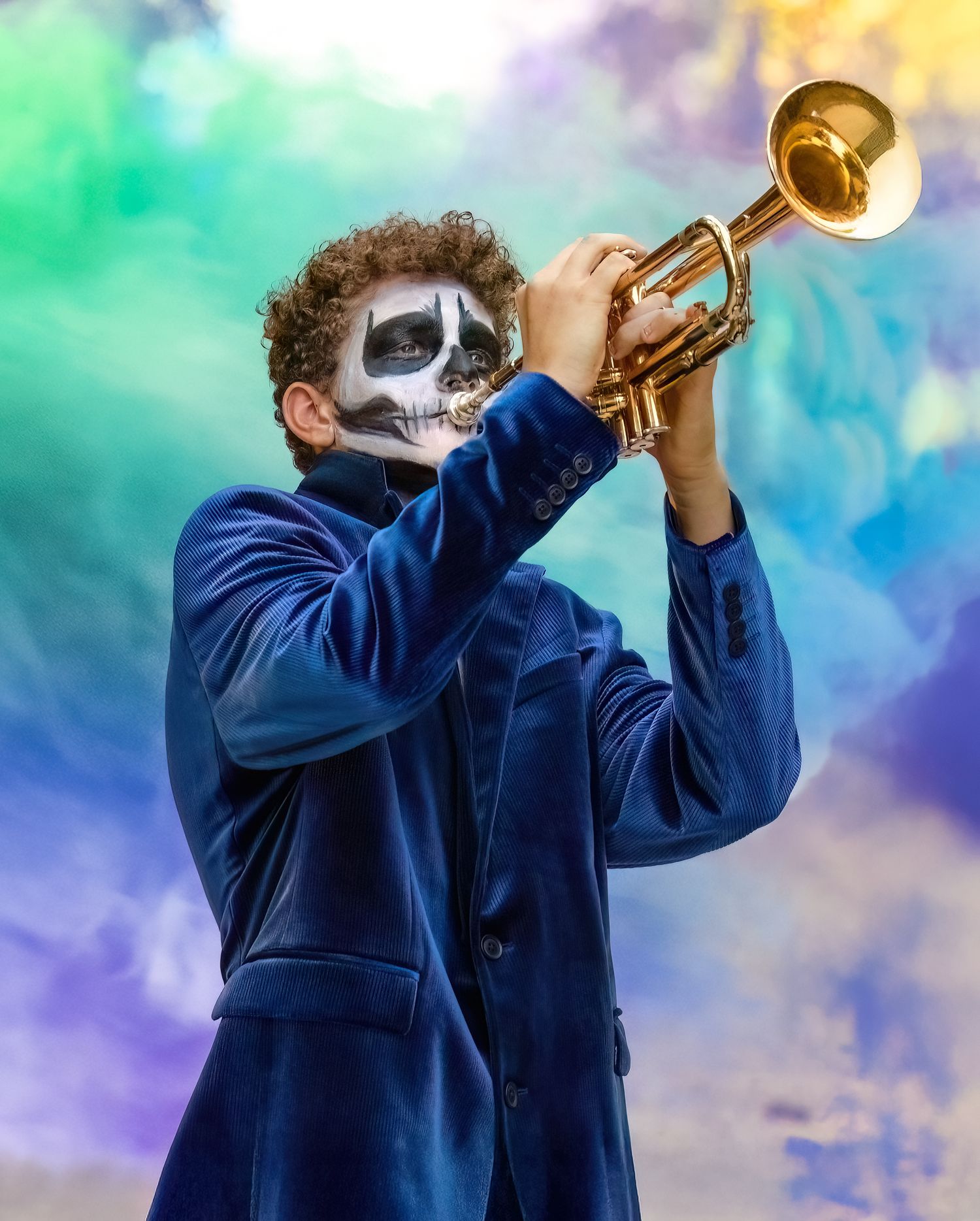 A musician in a navy blue jacket plays a trumpet against a colorful rainbow-hued background.