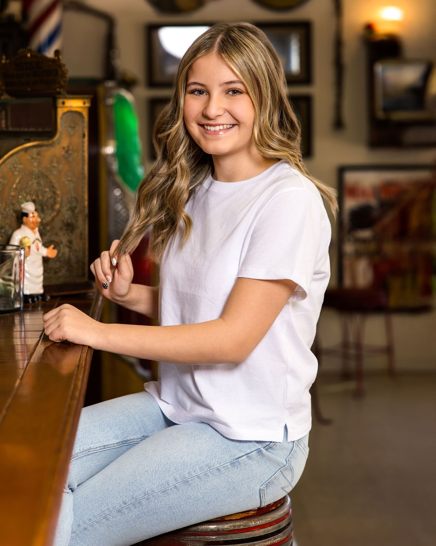 Casual portrait at vintage diner counter with white t-shirt and jeans.