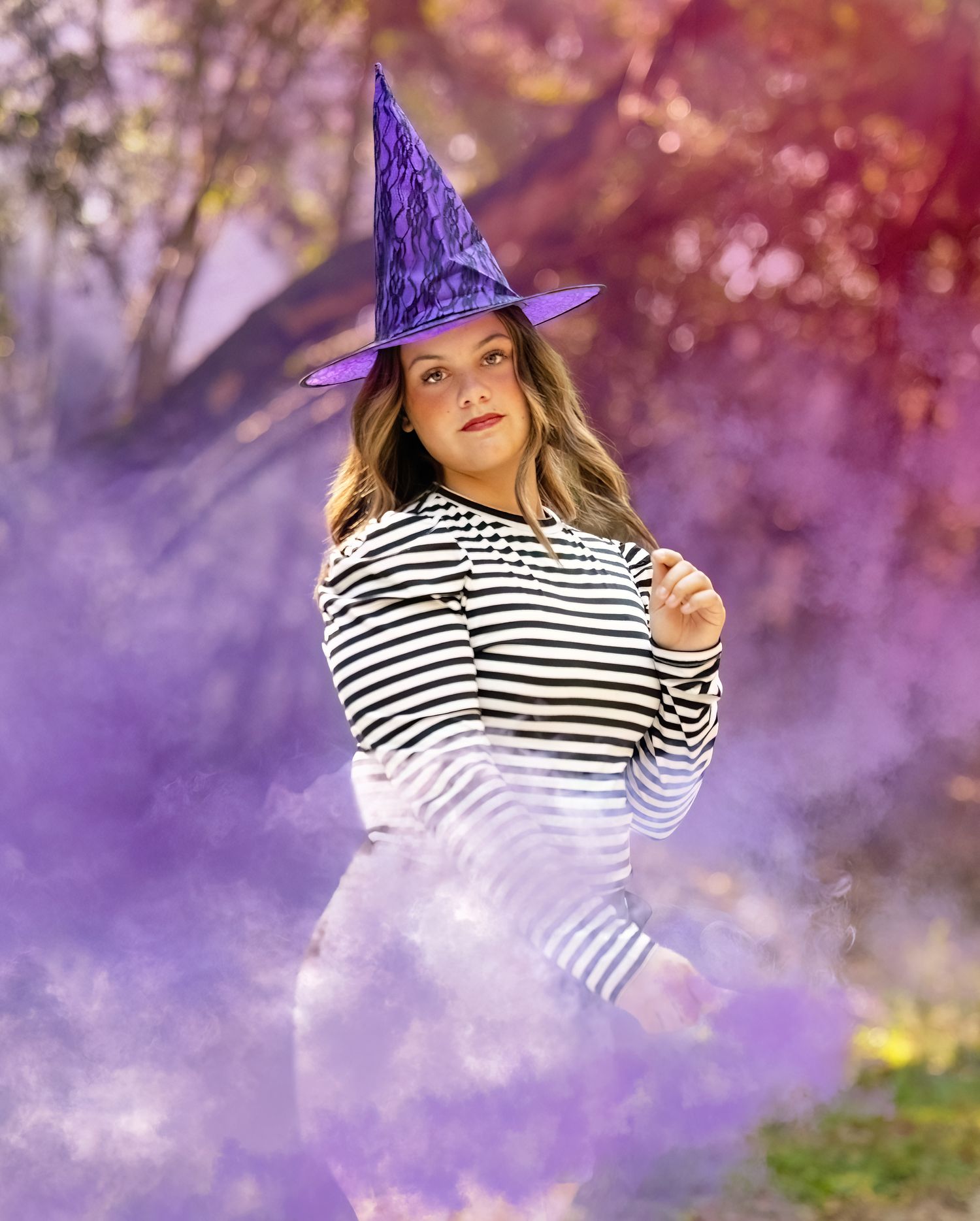Multiple shots of someone wearing a striped shirt and purple party hat with magical sparkle effects.