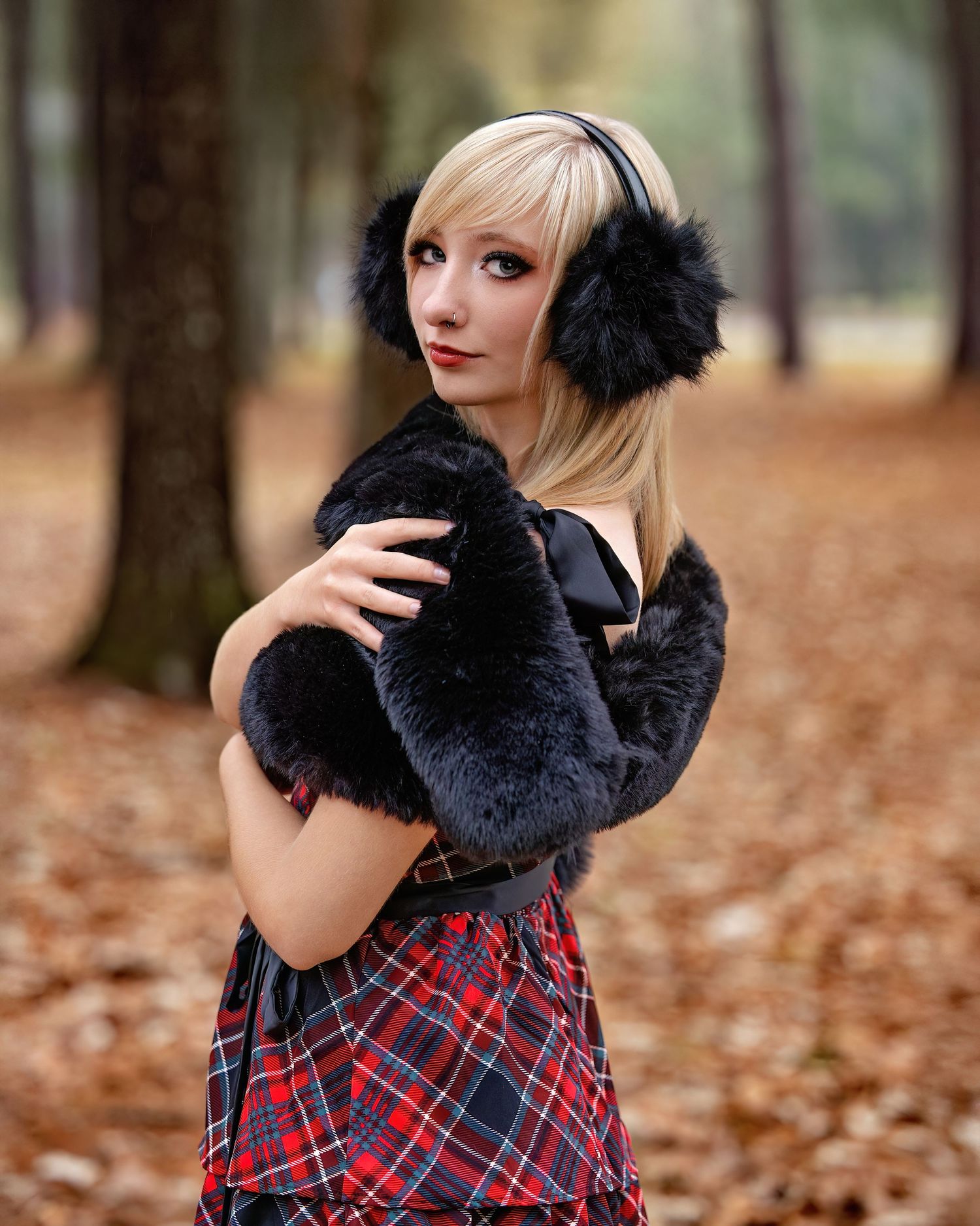 Senior portrait featuring a plaid dress and black fur accessory against a backdrop of fallen leaves.  Jaylin, I love this.