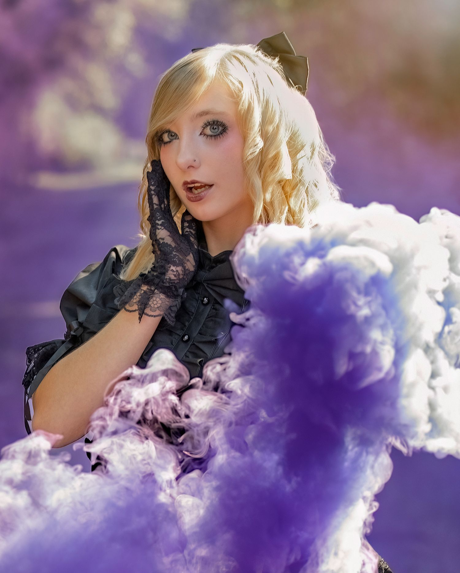 Gothic style portrait with black lace and bow details surrounded by dramatic purple and white smoke effects.