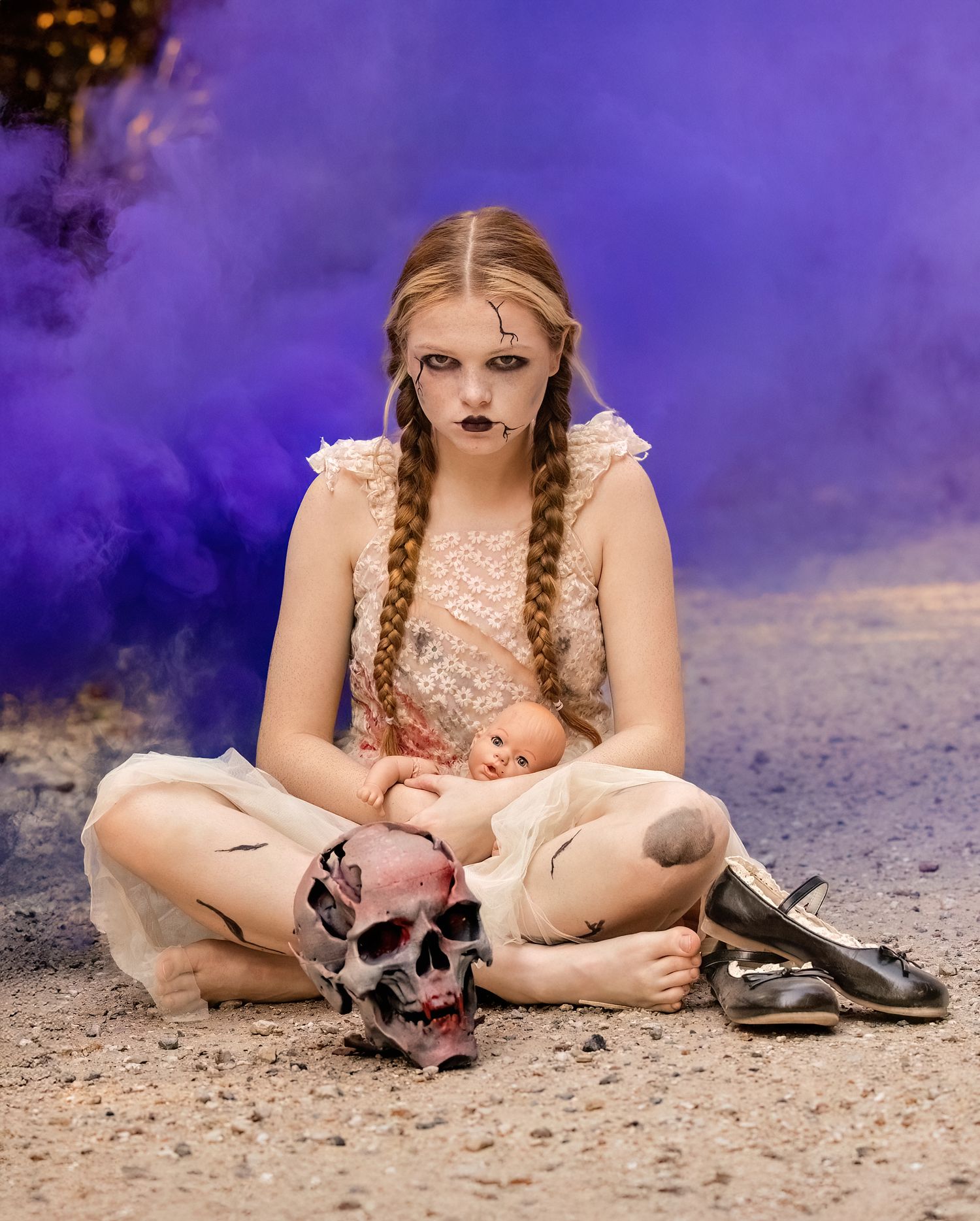 Gothic themed portrait with skull prop and purple smoke effects.