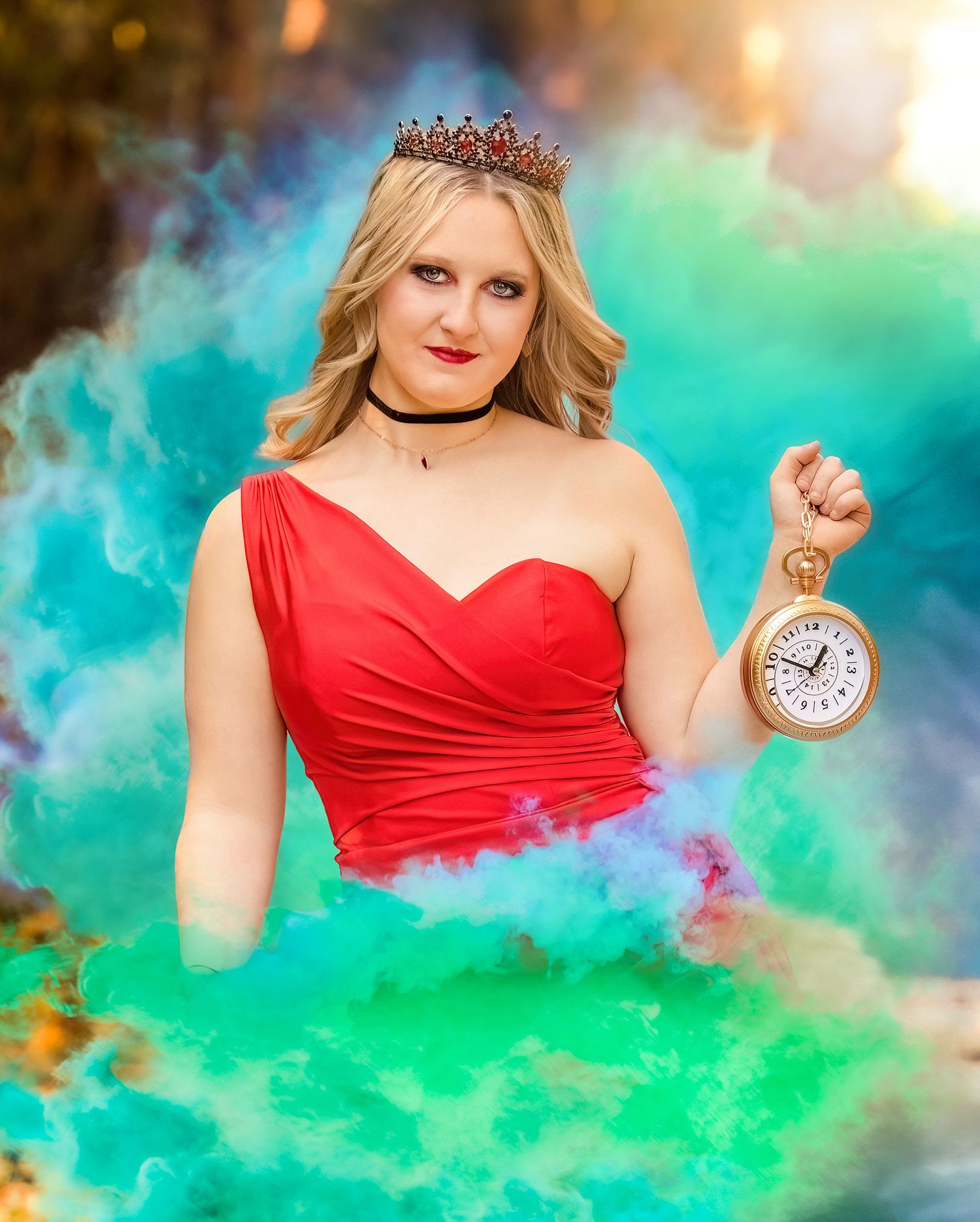 A dreamy fantasy portrait in red dress against turquoise smoke holding a vintage pocket watch.