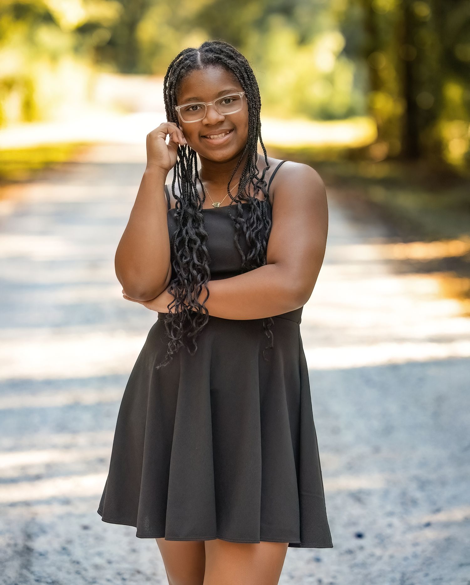 A series of outdoor portrait photos showing someone in a black dress against a sunlit natural background.