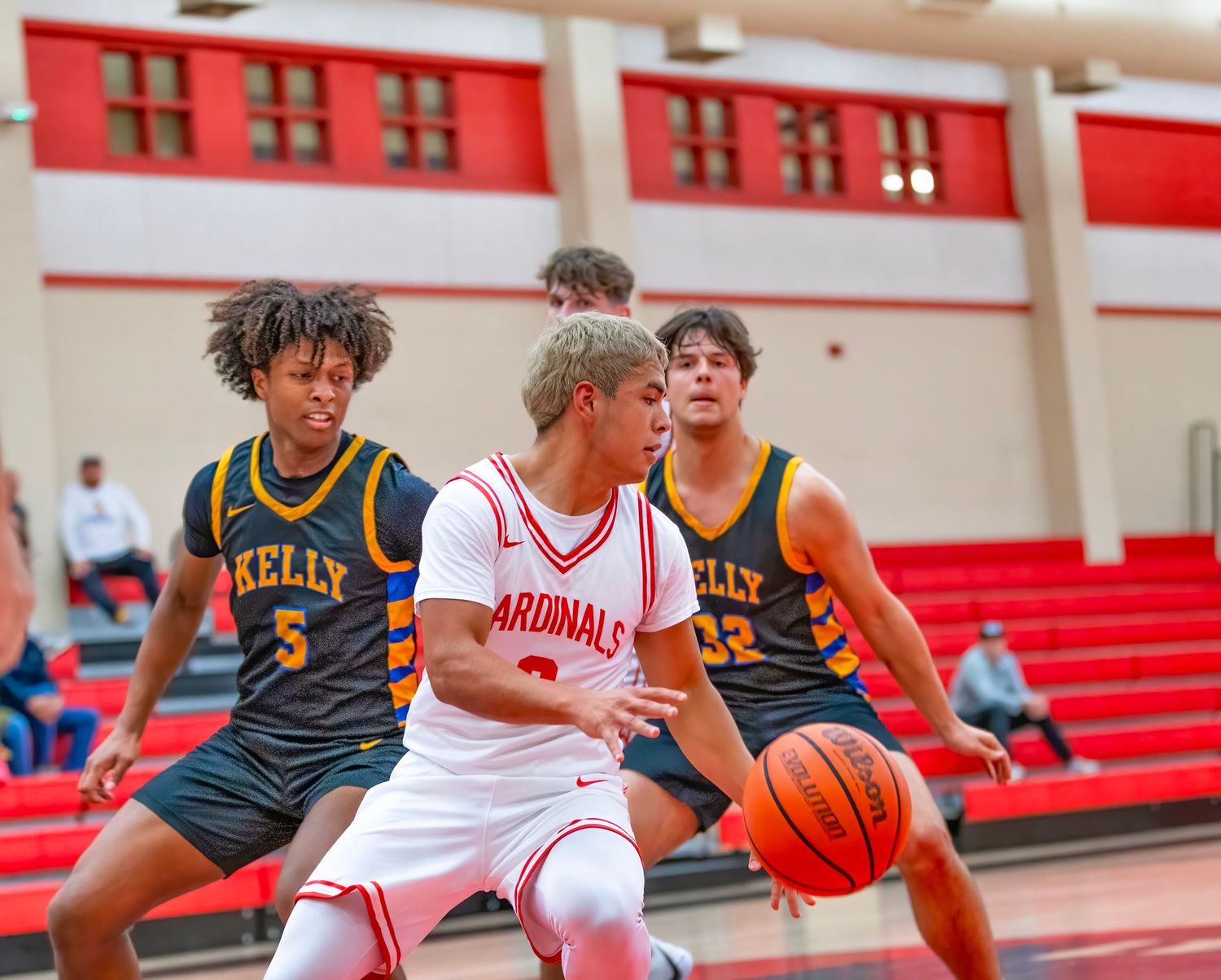 Sport Game Live High school basketball players in white and navy uniforms compete for possession of the ball during a game.