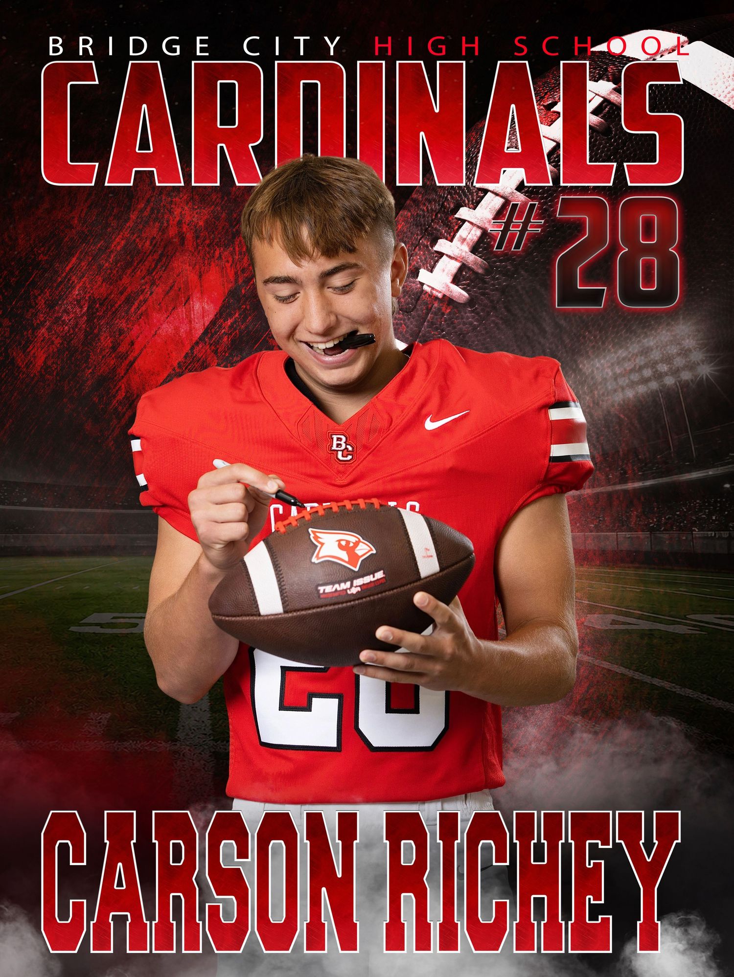 Bridge City High School Cardinals #28 Carson Richey in red football uniform holding a football for his senior sports portrait.