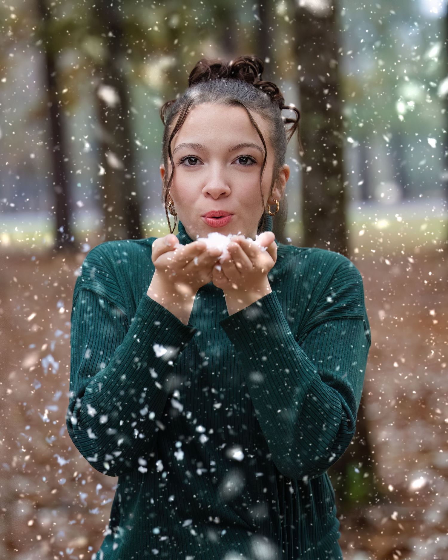 Atlayn blowing snowflakes during a magical winter snowfall.