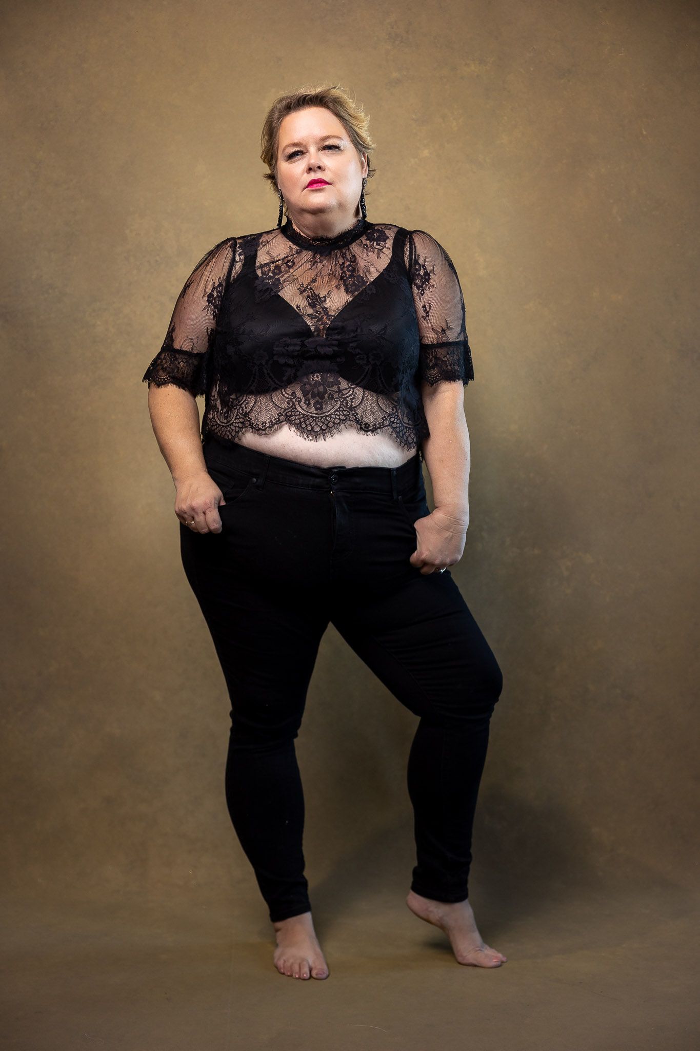 Black lace and sheer details create contrast in an artistic studio portrait series.