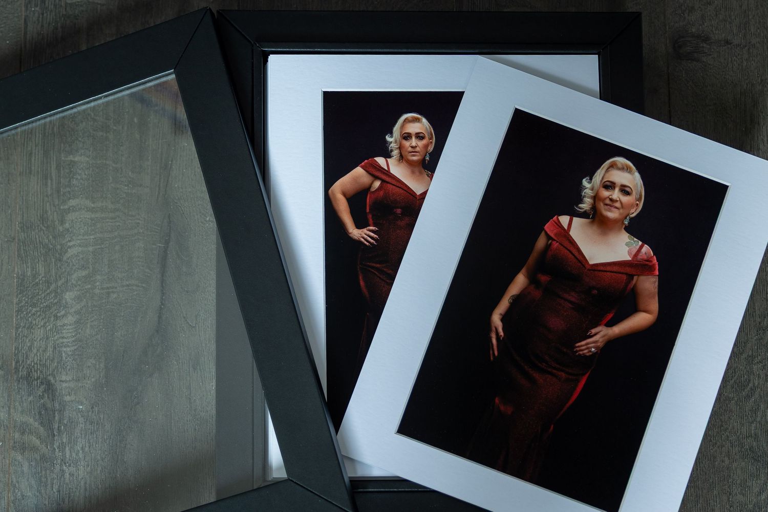 Professional photography portfolio album with leather cover and artistic portrait prints displayed.