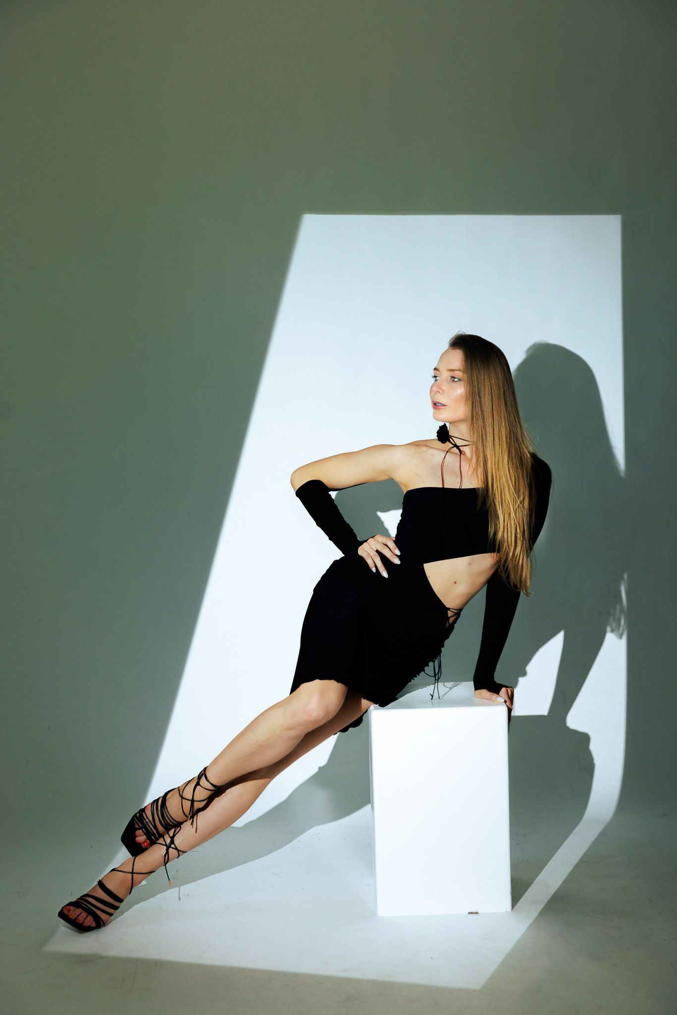 Minimalist fashion photography series with geometric white backdrop and dramatic shadows.