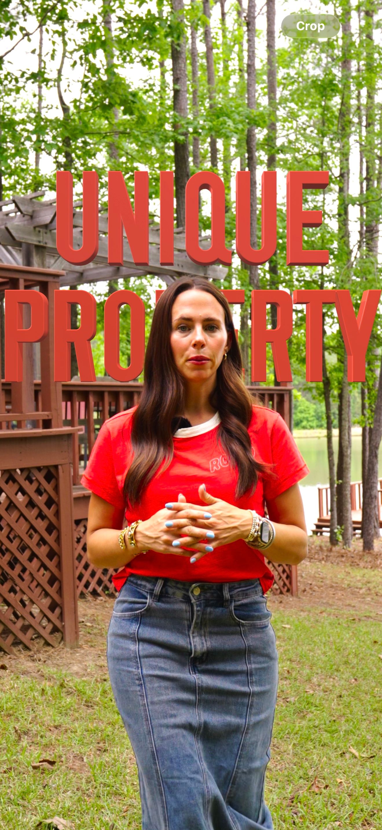 Woman in red shirt and denim skirt stands outdoors with 'Unique Property' text overlay near a wooden deck.
