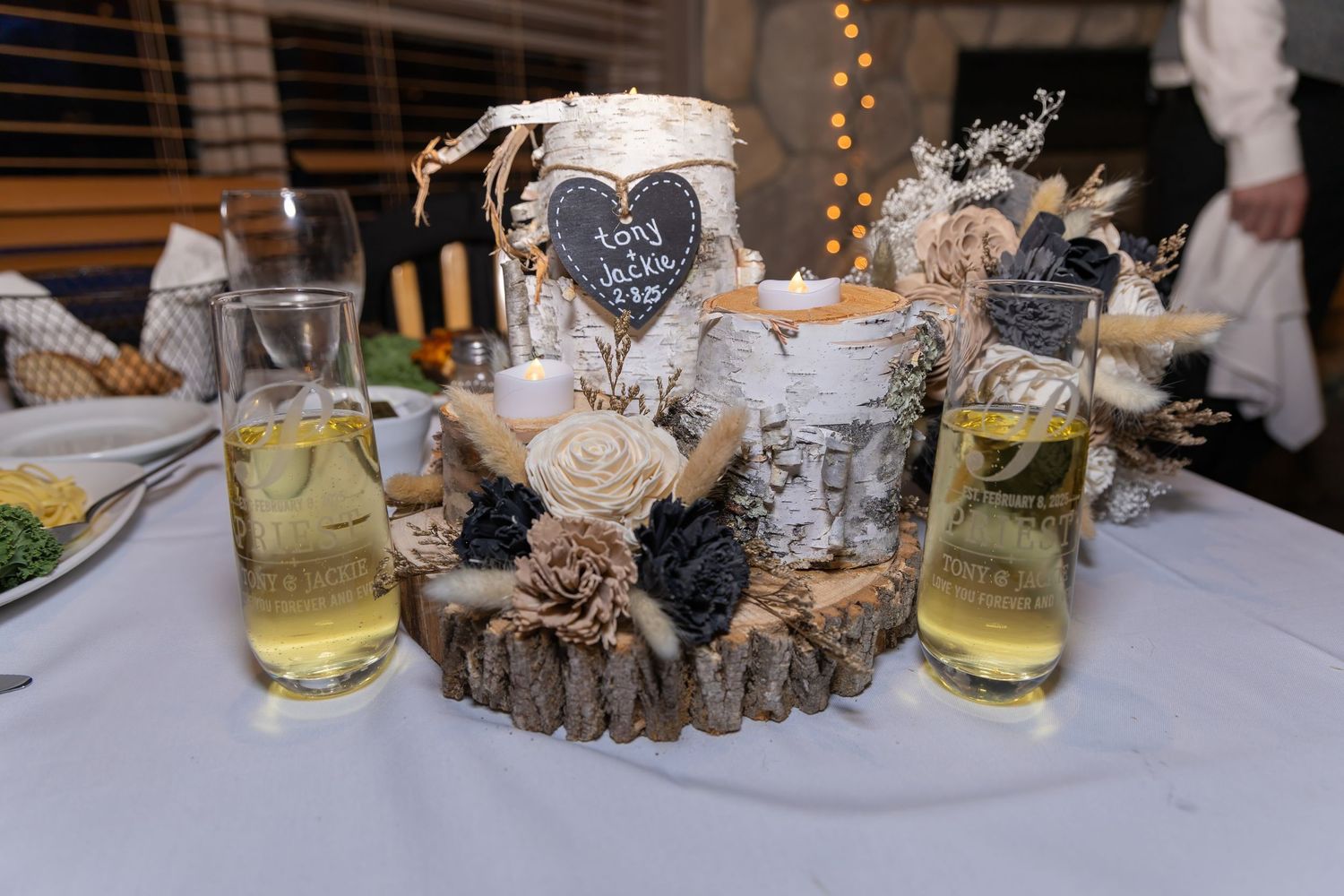 Wedding table settings with wood slice centerpieces and decorative elements in natural tones.