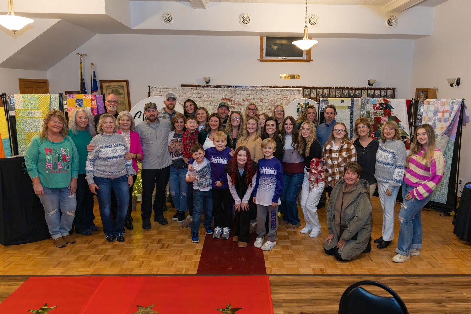 Large group photo of event attendees gathered in a community space.