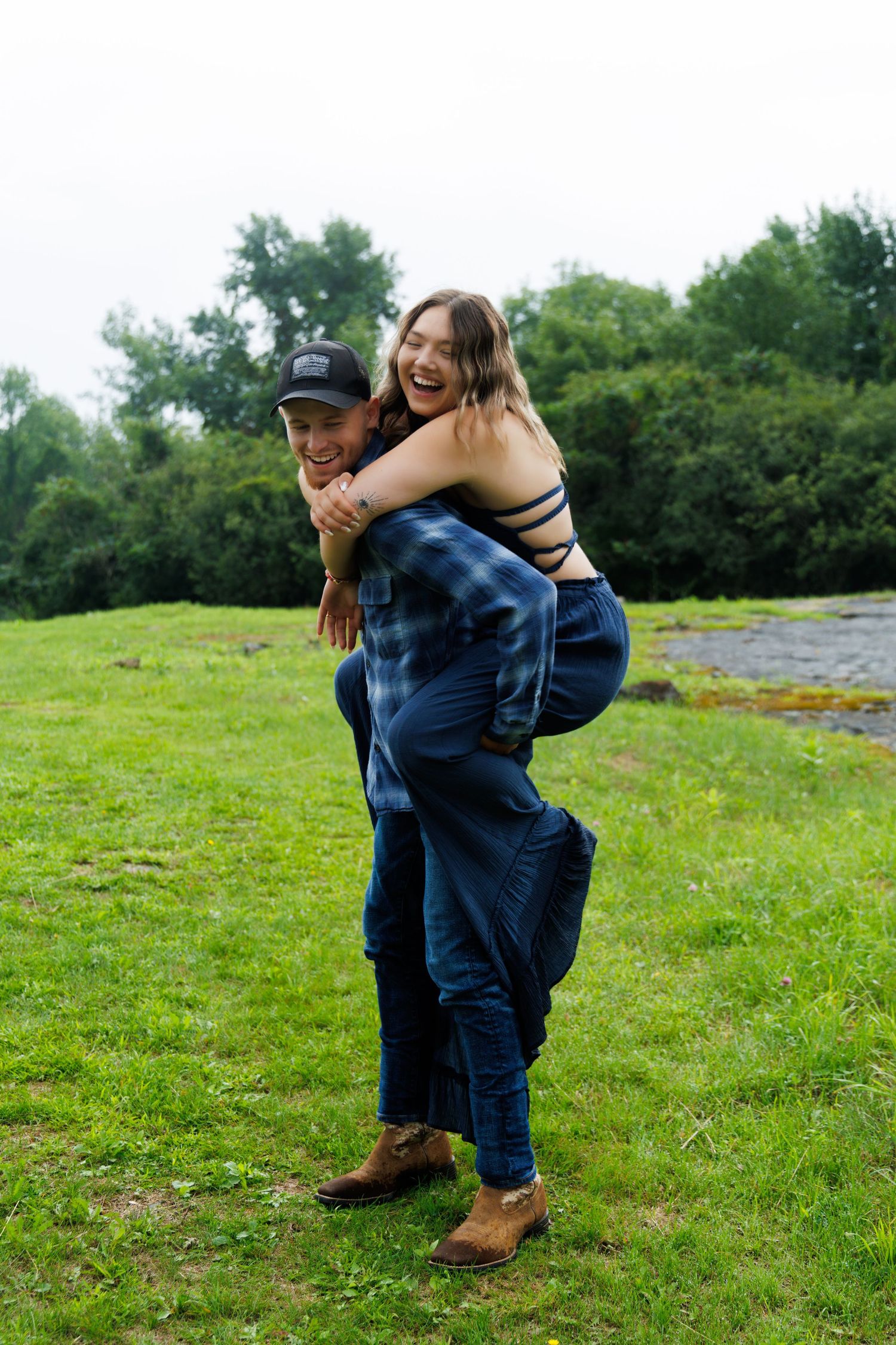 A playful piggyback ride moment captured in a lush green field.