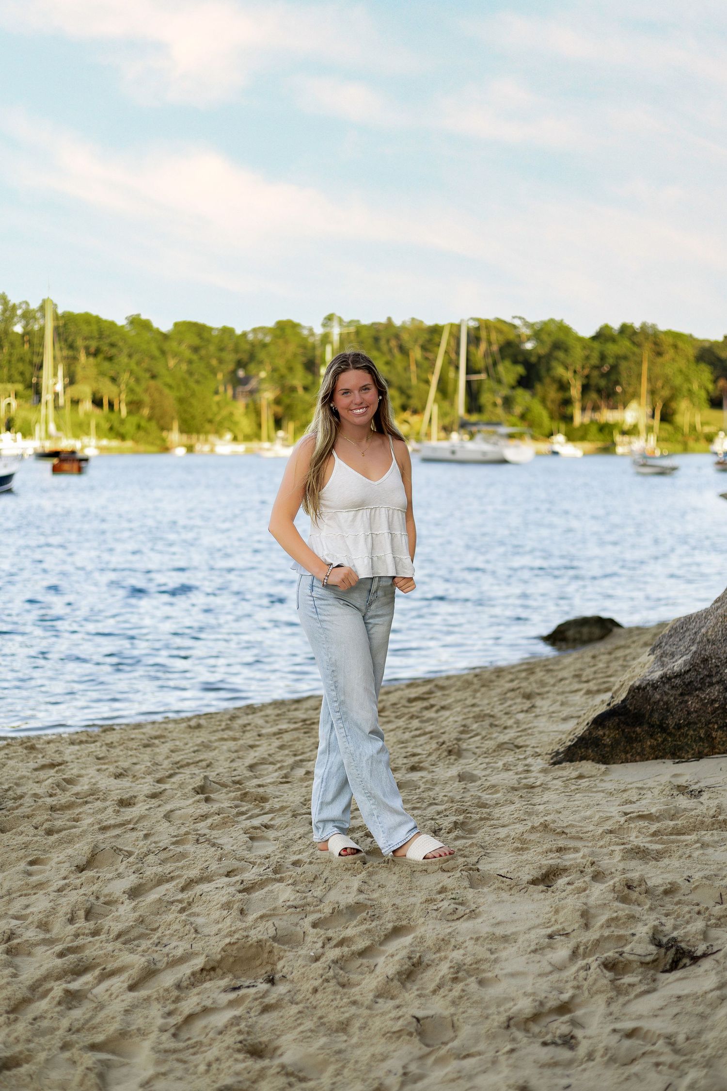 Casual beach portraits with sailboats and harbor views in the background.