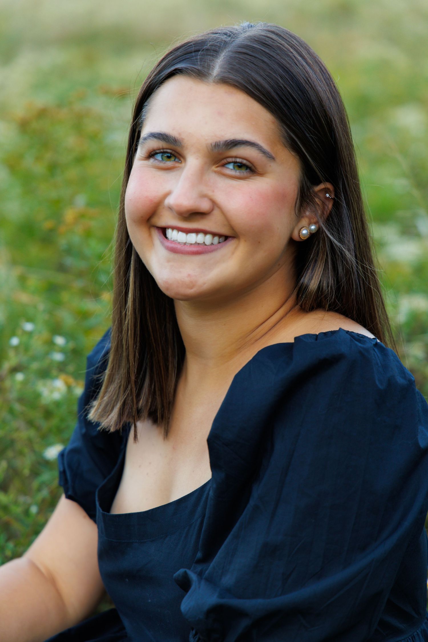Close-up outdoor portraits showing joyful expressions against a natural background.
