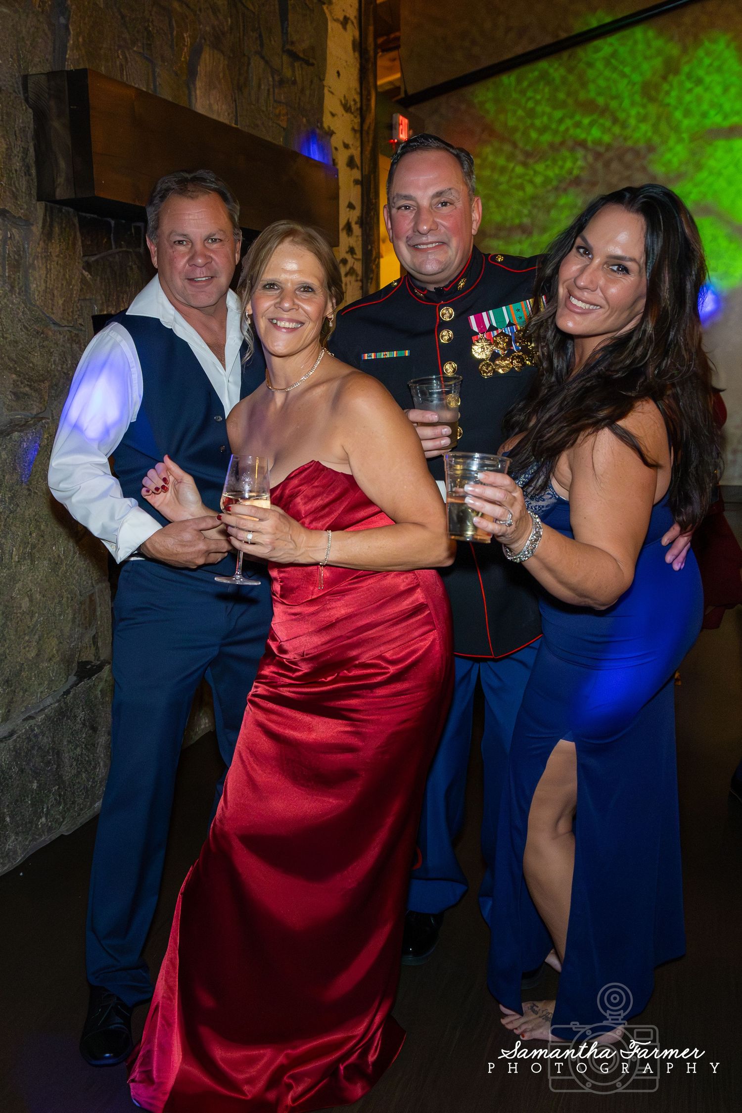 Guests in formal attire dancing at a reception, with people wearing navy blue and red dresses.