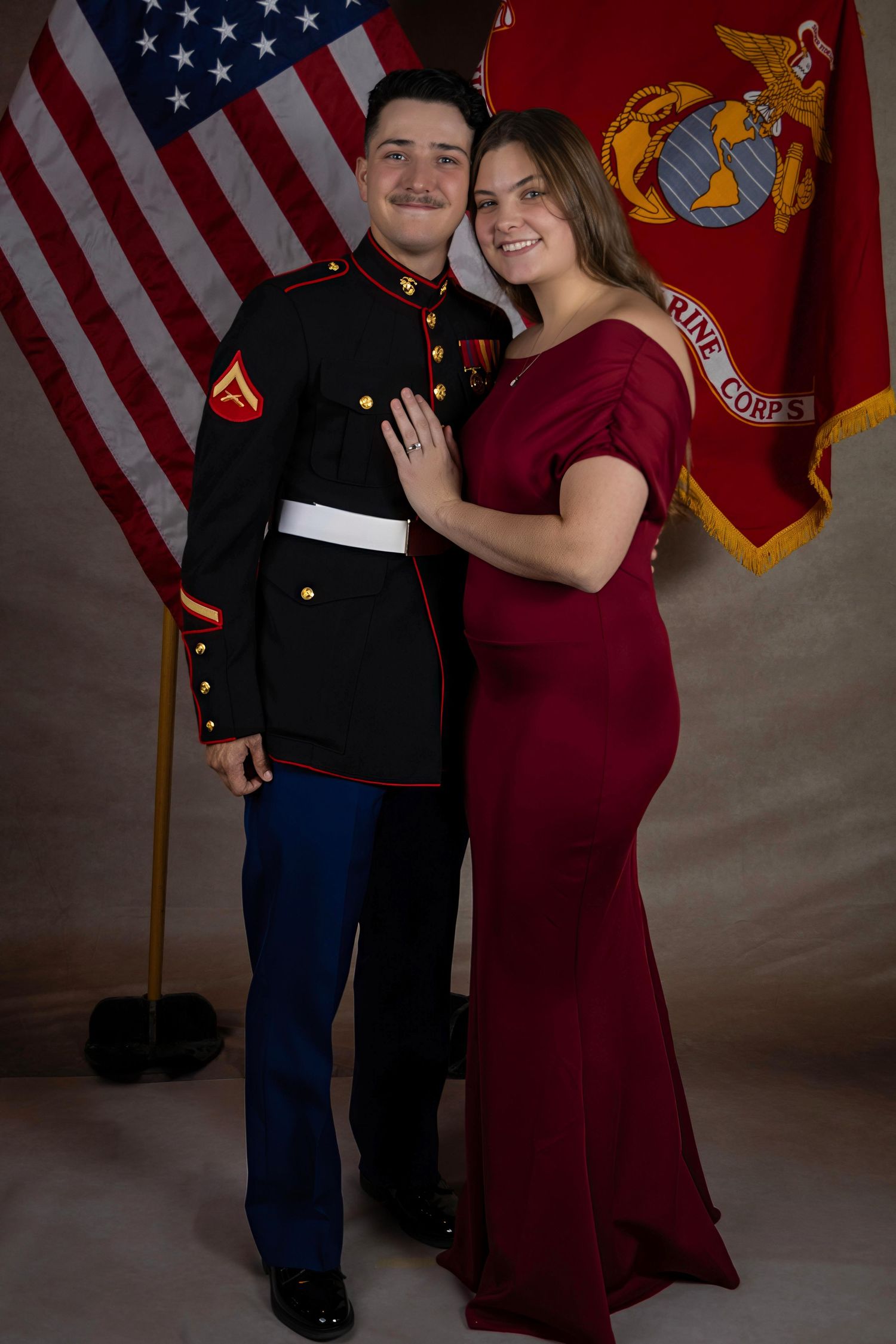 Formal portraits against backdrop with American and Marine Corps flags.