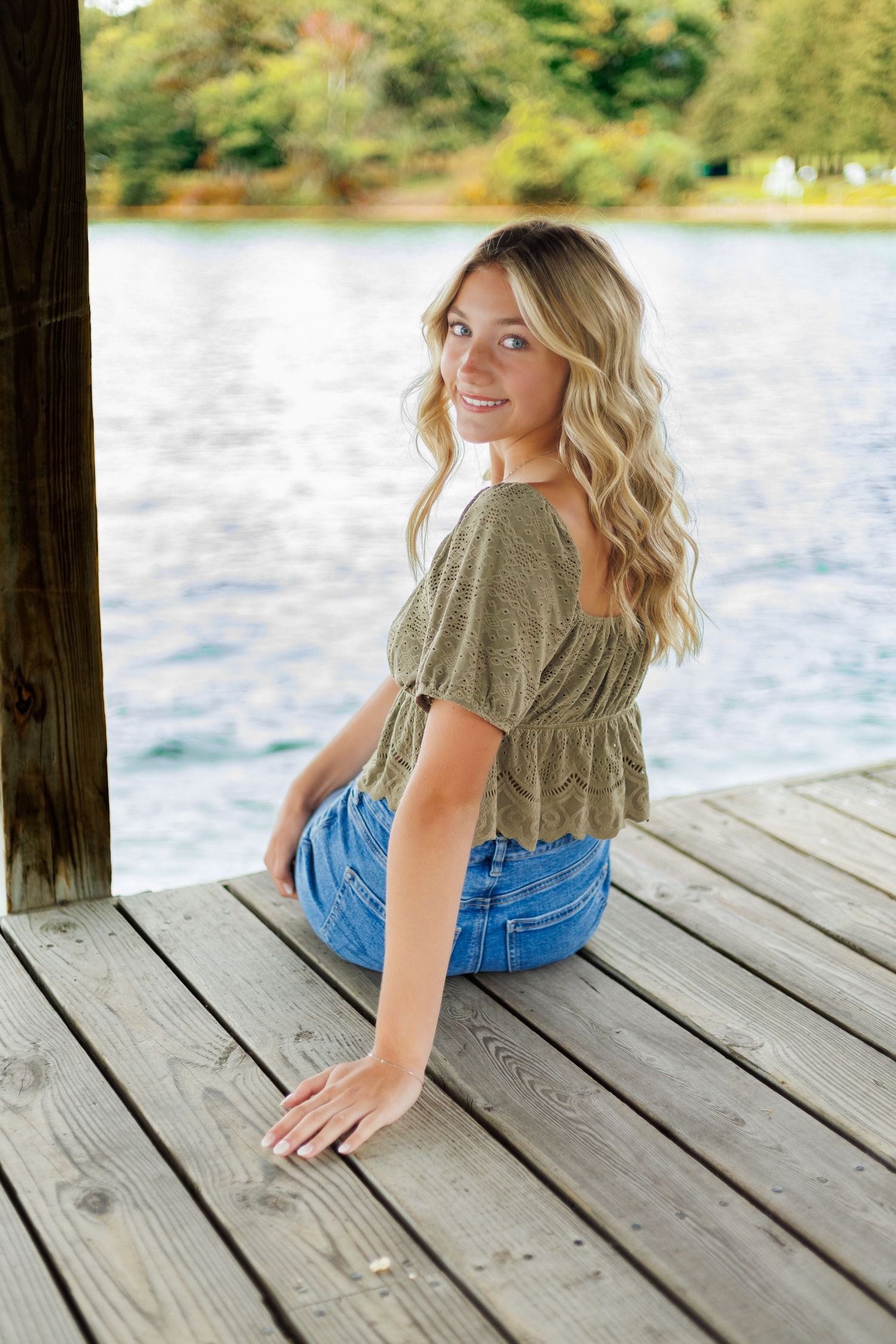 Casual summer portraits on a wooden dock overlooking a serene lake.