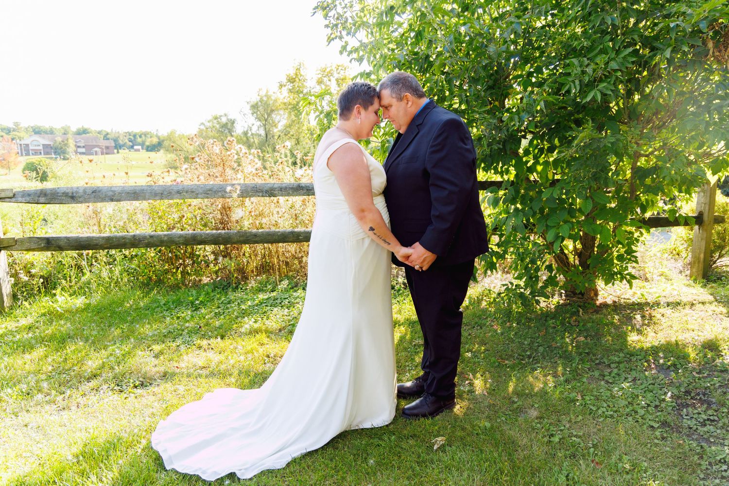 Outdoor wedding photography session in a green natural setting.